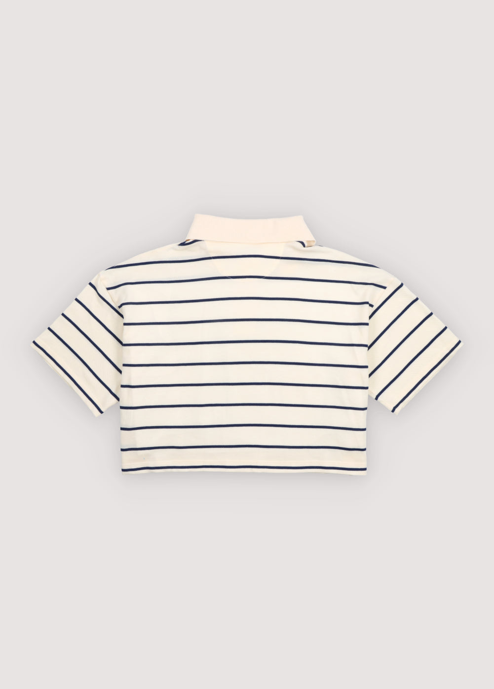 Cropped polo crafted in soft piqué fabric, featuring contrasting stripes and a structured twill collar.