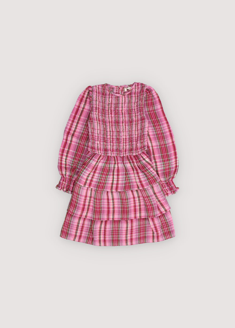 A charming special dress crafted from soft checkered double gauze, featuring a smocked bodice and an elasticated fitted waistband for a comfortable, flattering fit. The skirt is adorned withn ruffles, and the back opening includes a teardrop cut with a button closure, adding a subtle, elegant detail.