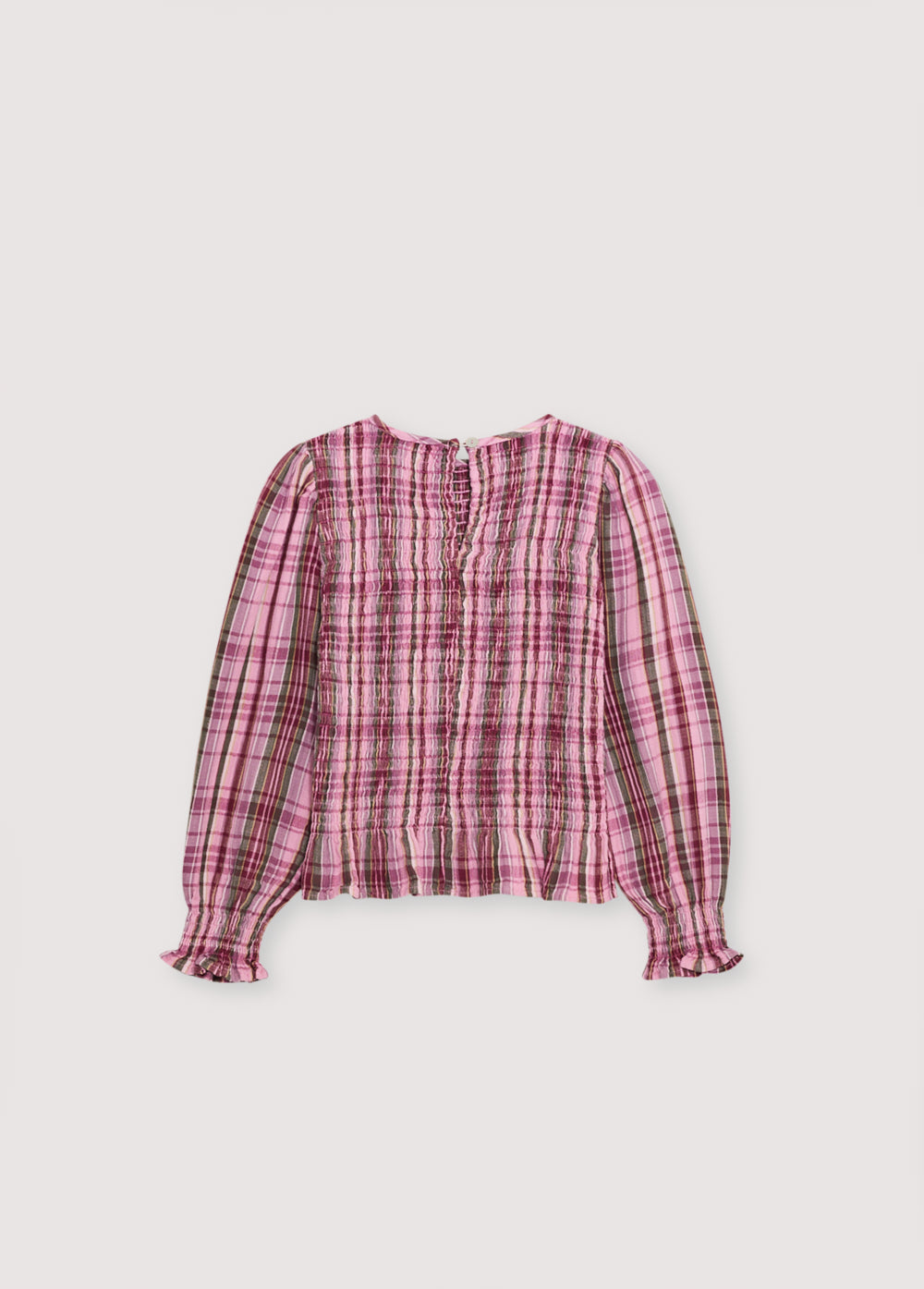 Checkered double gauze blouse with a smocked bodice and ruffle trim at the hem. It features slightly puffed sleeves and a back opening with a teardrop-shaped cut and button closure. Comes with a matching skirt to complete the look.