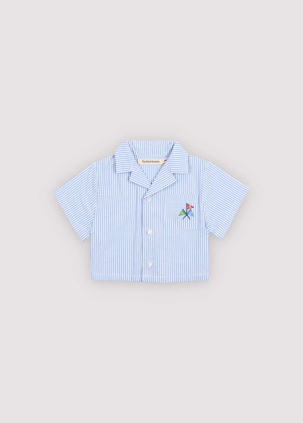 Short-sleeve shirt crafted from 100% cotton seersucker, featuring a front pocket and a playful, vibrant branded embroidery.