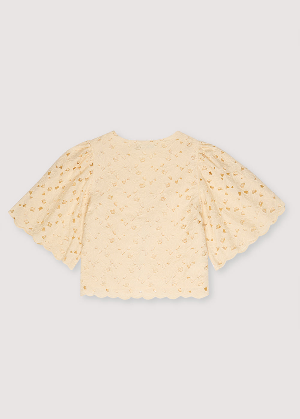 Atenea Woman Blouse in embroidered blend cotton fabric in macadamia color, featuring gathered sleeves, a V-neck, and closure with two bows in the center. Spring Summer Collection. The New Society