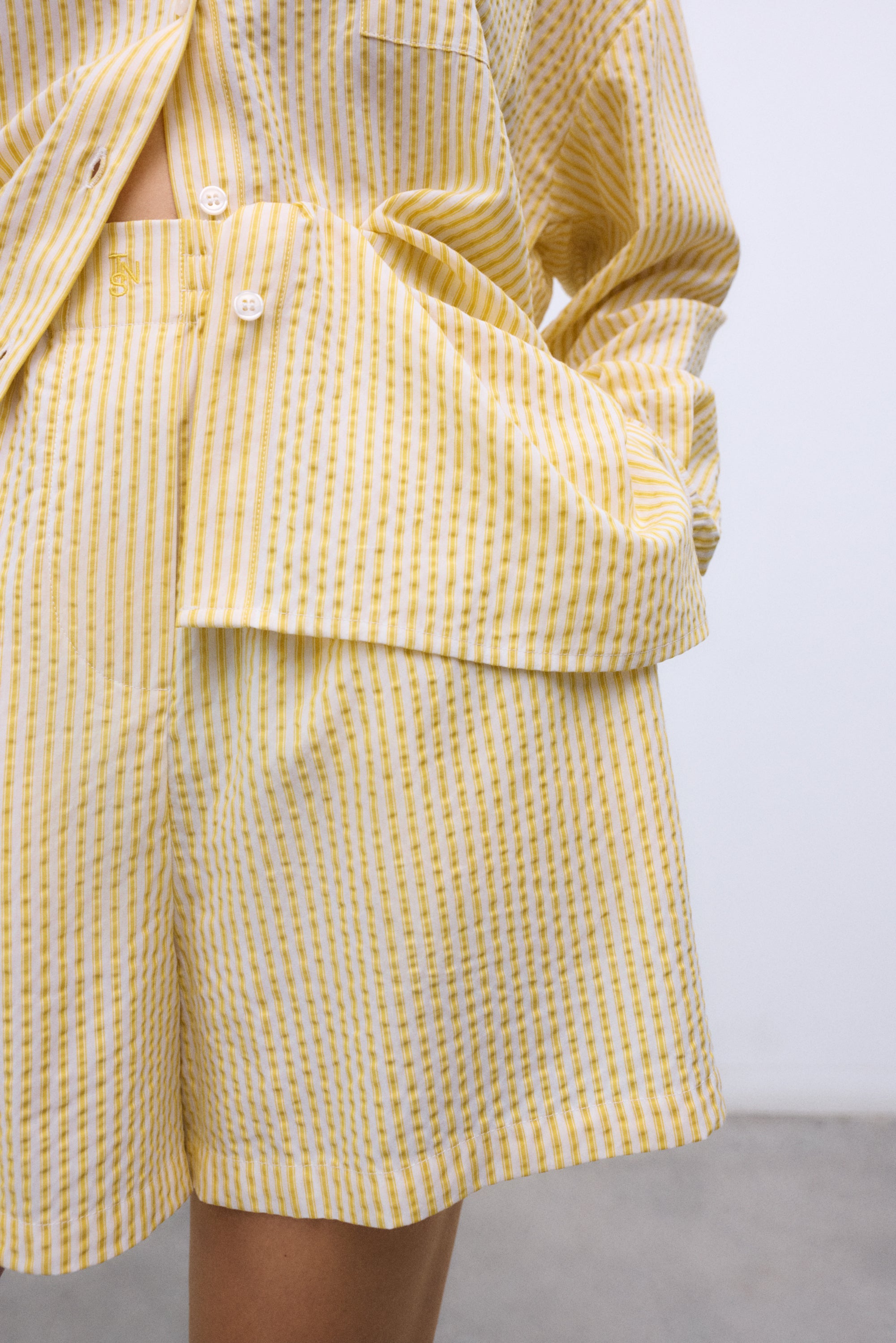 Crafted from 100% Tencel, these striped shorts in a vibrant yellow hue are fresh, soft, and effortlessly versatile.