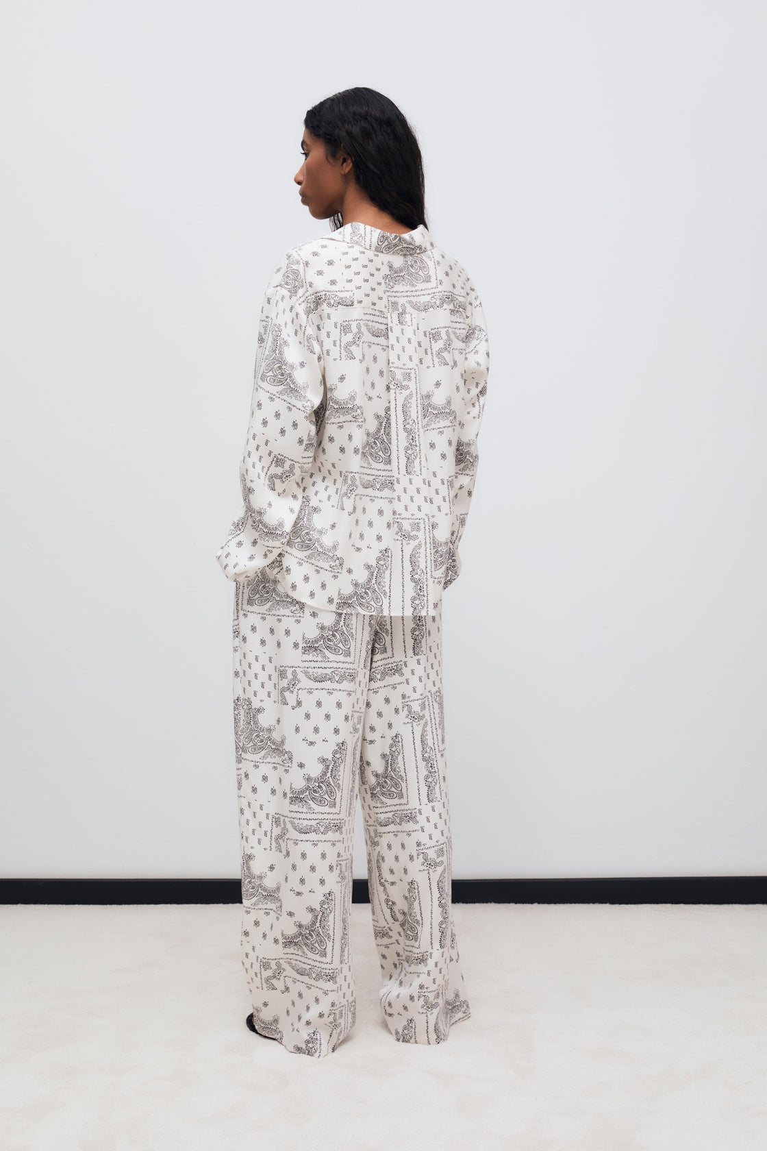 Wide-leg pants made of 100% Tencel with a beautiful bandana print and an elastic waistband. It features side pockets. It can be paired with the matching shirt and scarf to create a complete look.