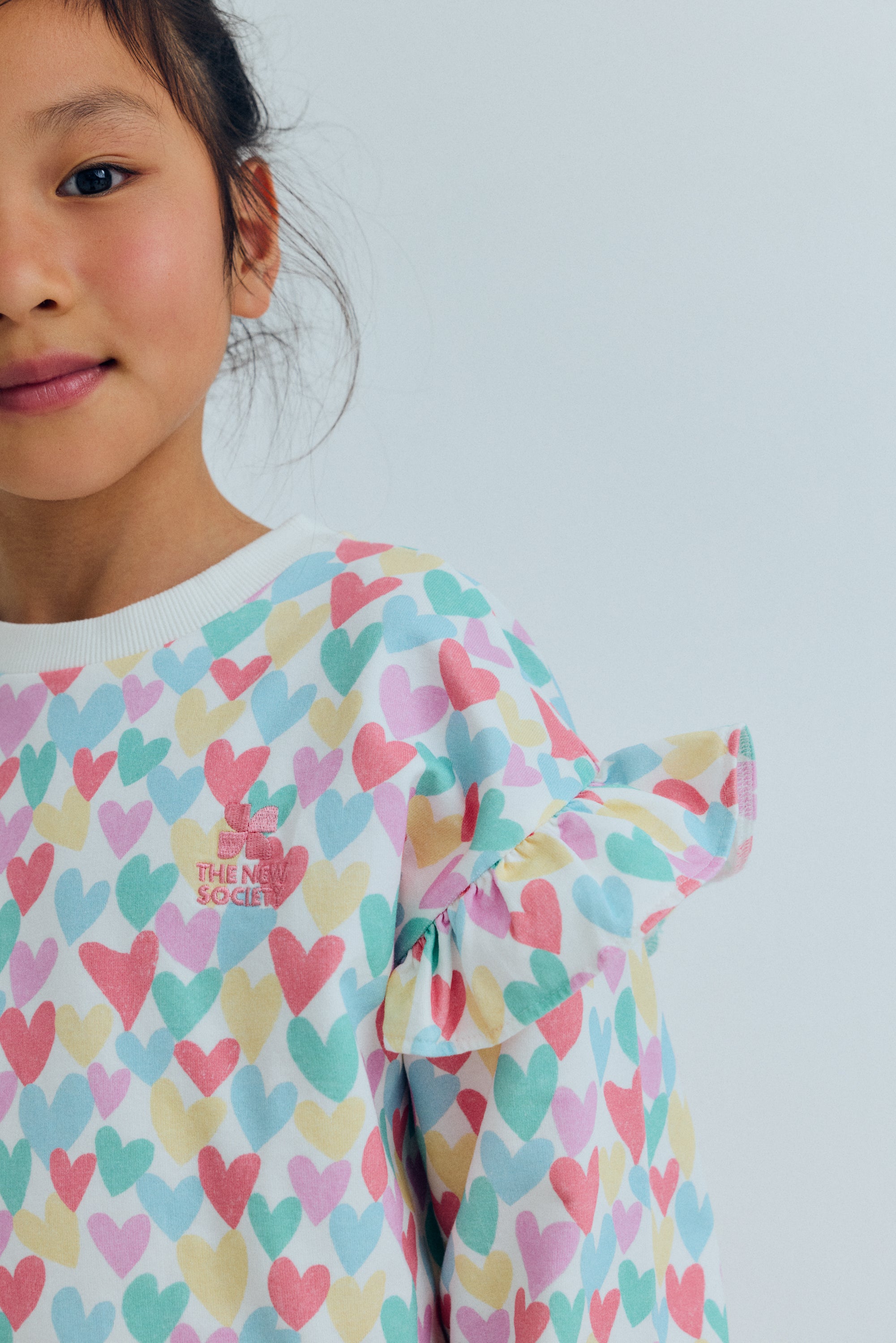 Kids sweatshirt with a playful multicolor heart print that adds a fun and cheerful touch to everyday outfits