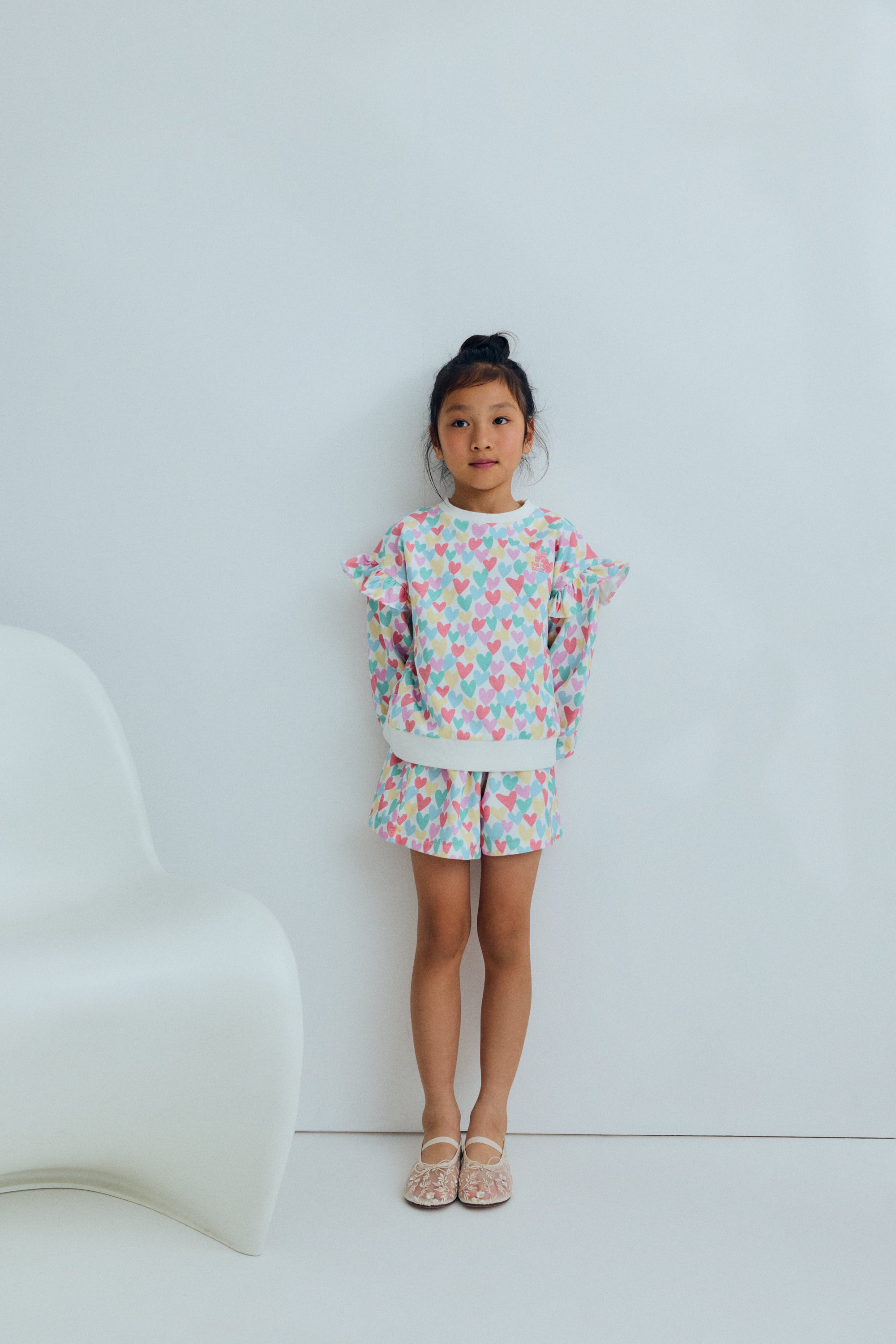 Kids sweatshirt with a playful multicolor heart print that adds a fun and cheerful touch to everyday outfits