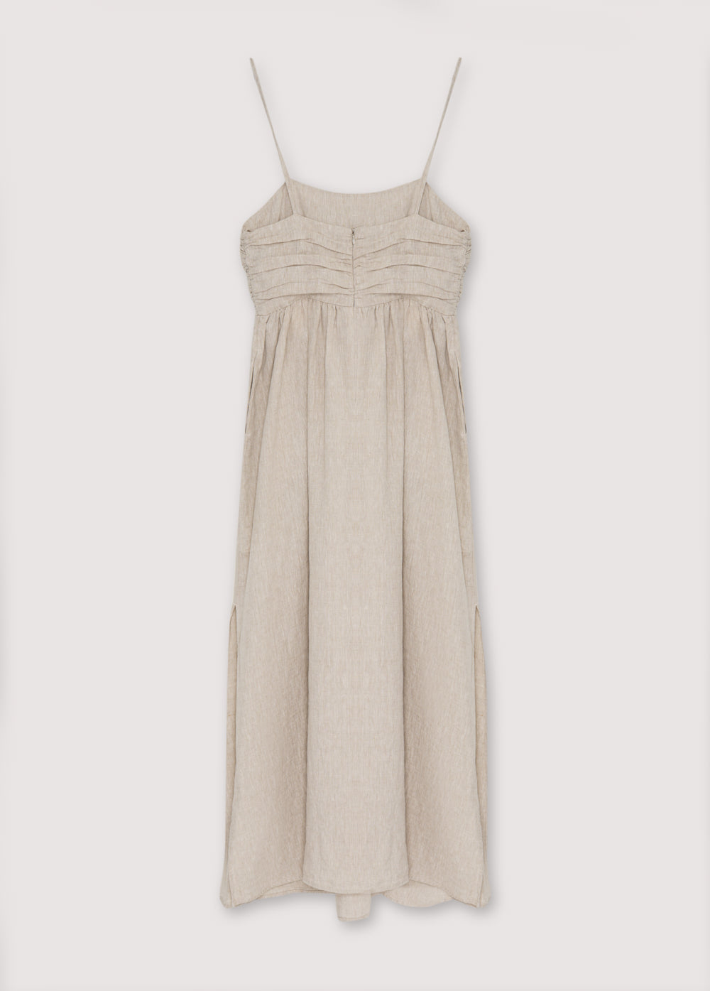 Anna Woman Dress in 100% linen fabric, with spaghetti straps, pleated panel on the top, and a long skirt with volume. Spring Summer collection. The New Society.