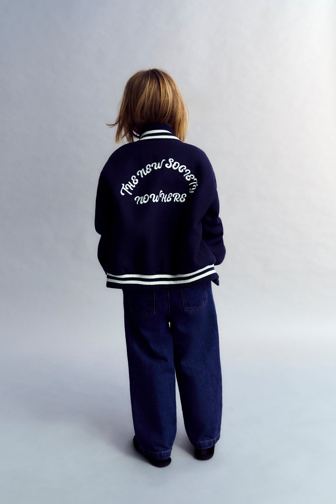 Bomber in wool quality with striped rib detailing in contrast color, featuring brand embroidery on the chest and back.