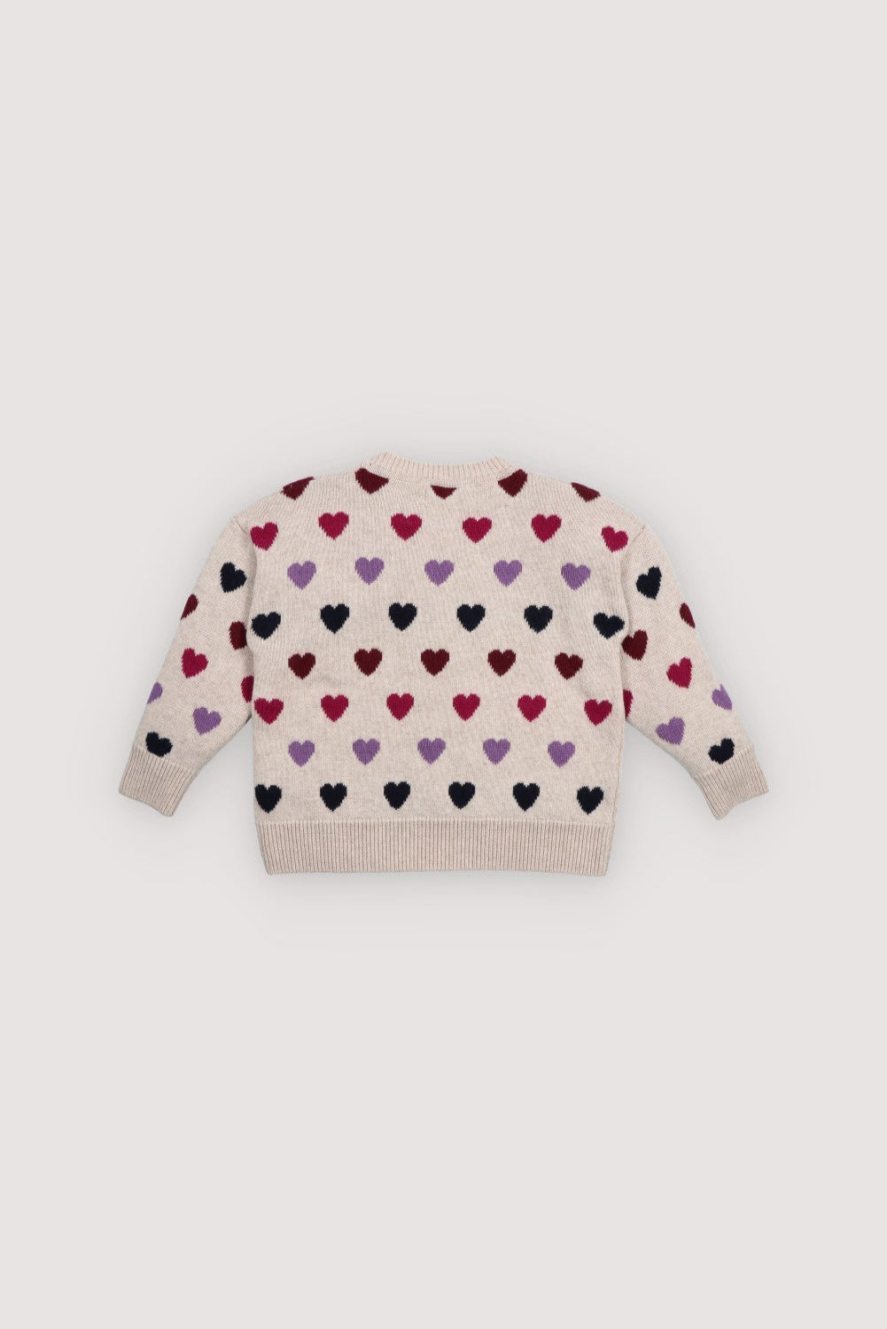 Knitted sweater with colorful heart pattern on a light background. The New Society kids collection AW25
