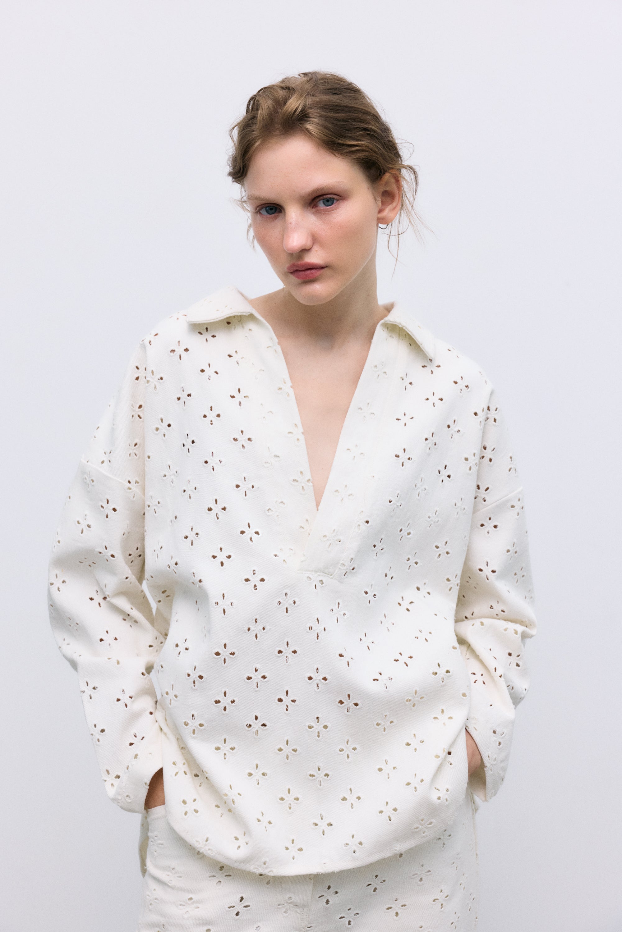 Polo-style blouse with a shirt collar and front opening, crafted from a delicate and special denim fabric featuring all-over embroidery for a unique textured finish
