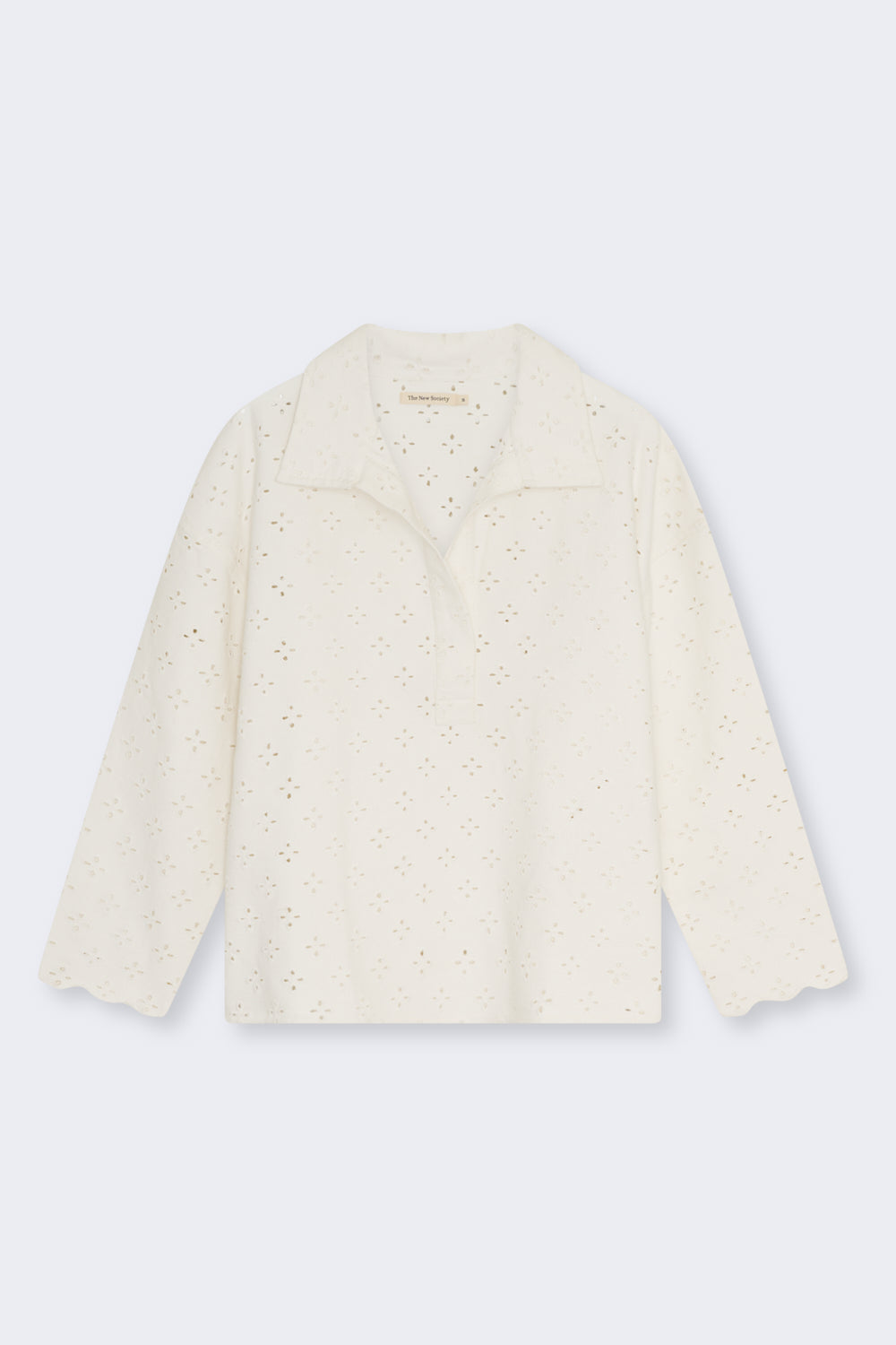 Polo-style blouse with a shirt collar and front opening, crafted from a delicate and special denim fabric featuring all-over embroidery for a unique textured finish.