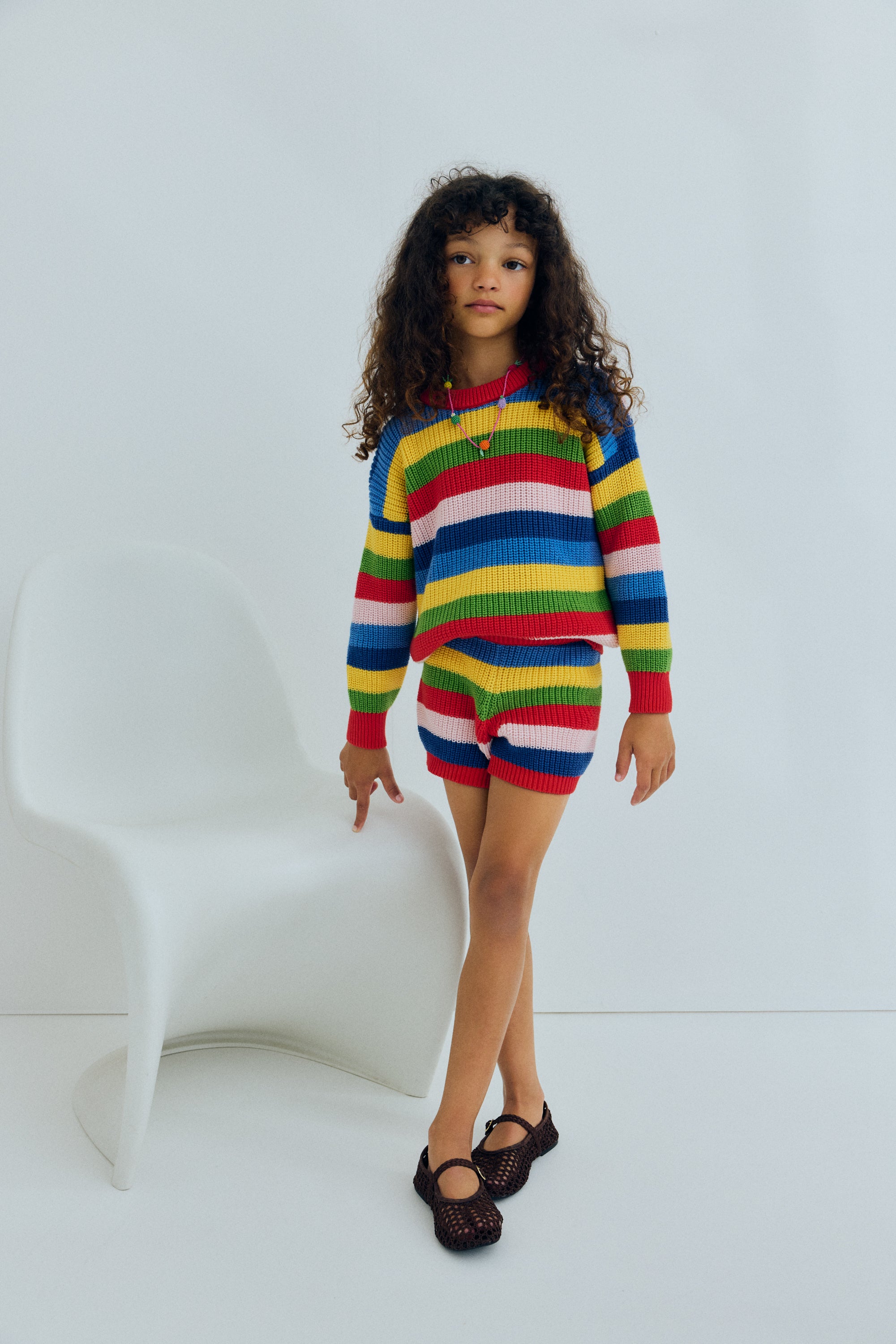 Fine cotton knit shorts featuring a playful multicolor stripe pattern and a ribbed elastic waistband for a comfortable fit