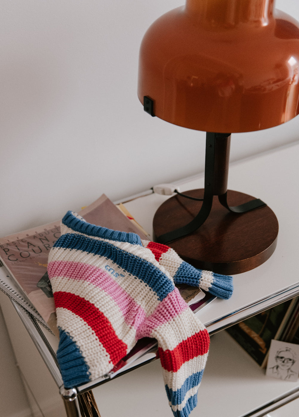 Baby striped cotton knit featuring fresh, summery colors and a charming embroidered logo detail on the chest.