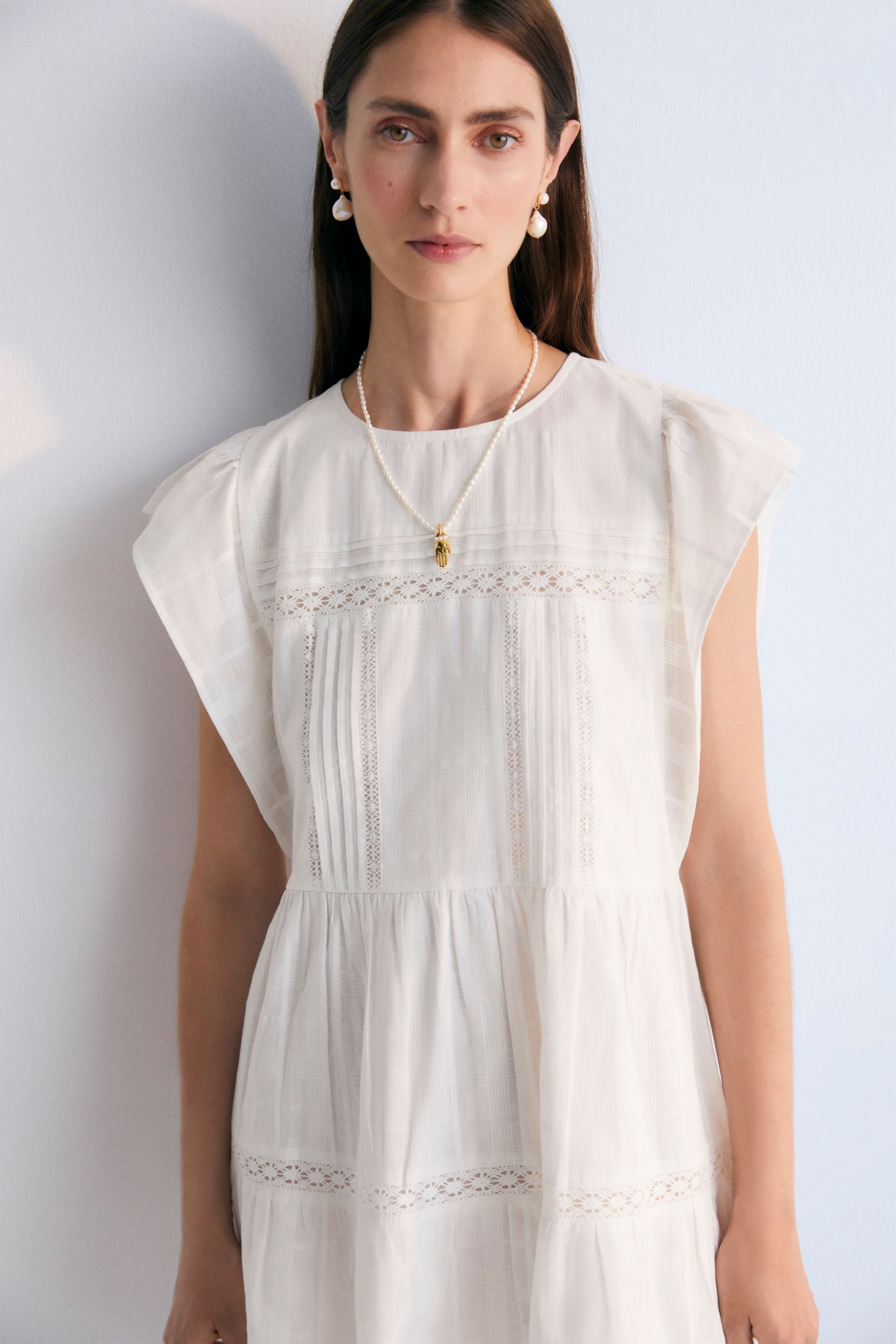 Short dress with jacquard fabric and lace details. It features ruffles on the sleeves and an opening at the back with mother-of-pearl button. Spring Summer Collection. The New Society.