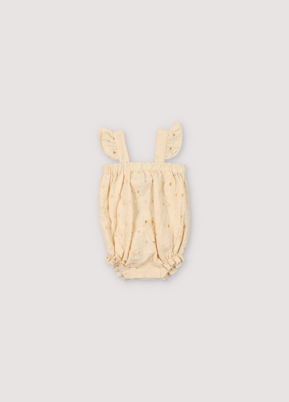 Creta Baby Romper in embroidered blend cotton fabric in macadamia color, with straps featuring ruffle details, elastic at the chest and legs with ruffle details, and snap closure in matching color. Spring Summer Collection. The New Society.