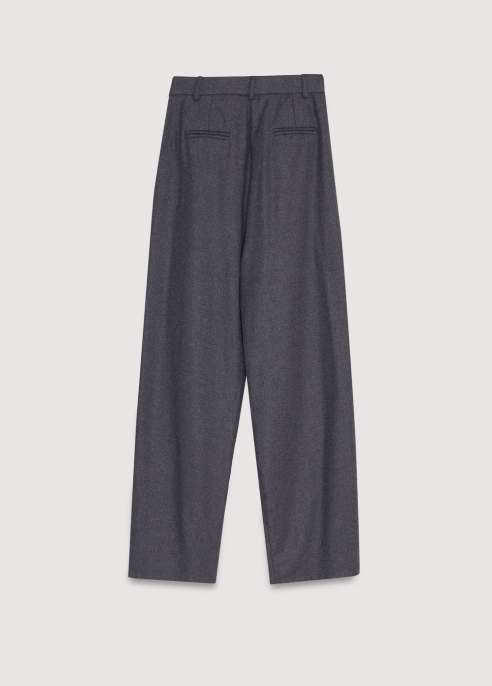 Wool pant with pleat detail in the front and side pockets. They feature a waistband with a hidden button closure.