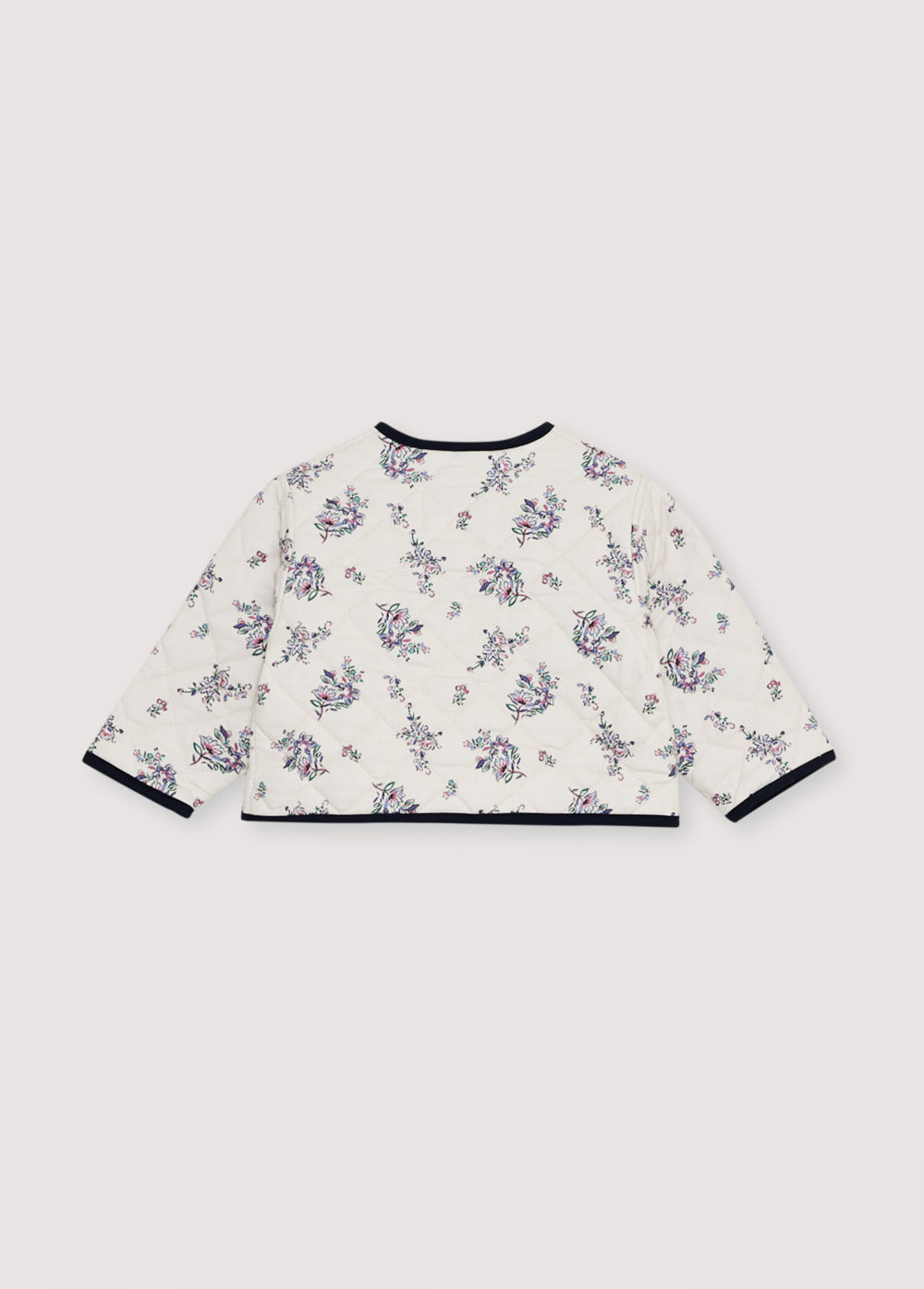 Quilted jacket with a floral print exterior and contrasting striped interior. It loses with wooden buttons.