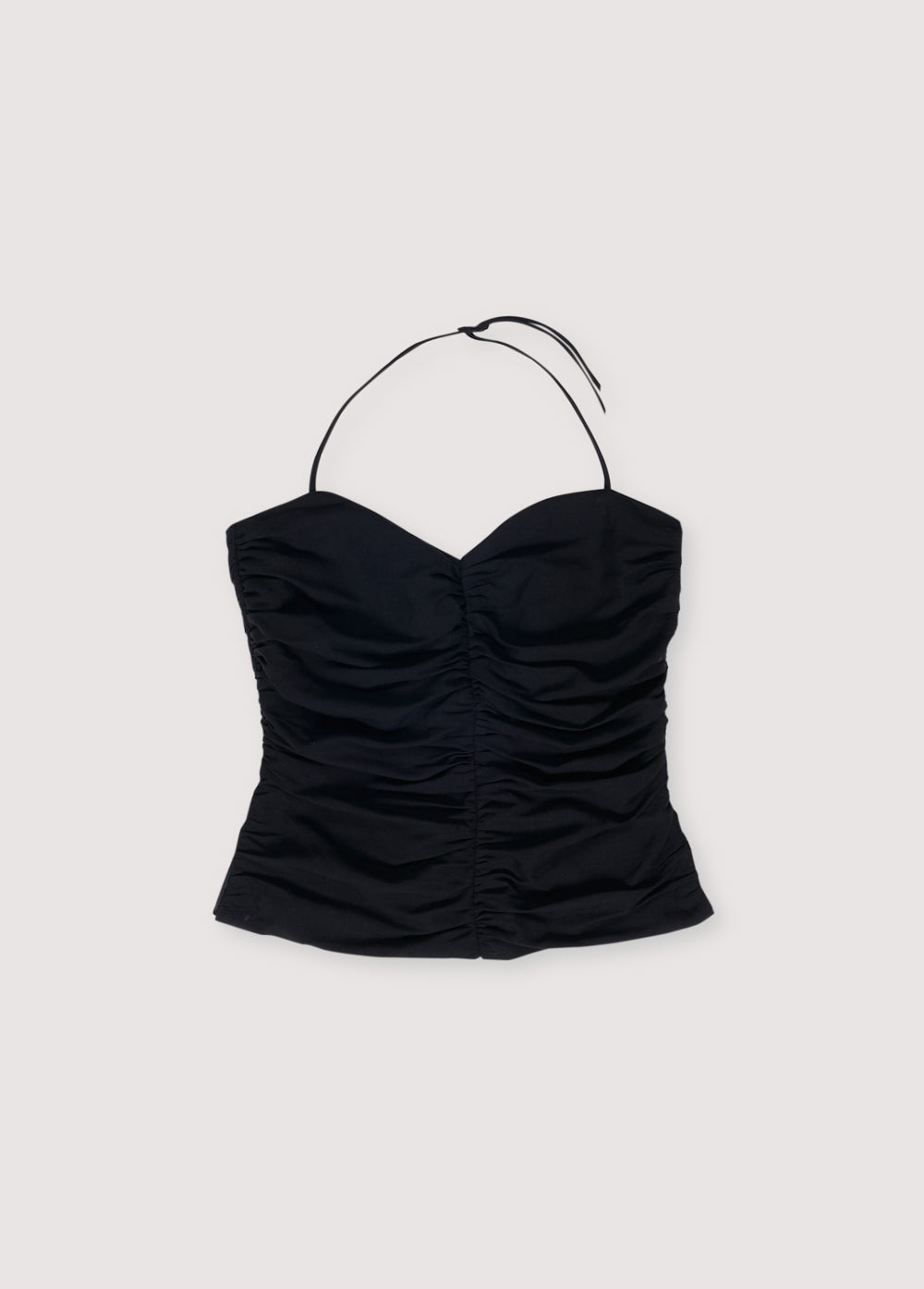 Rayon/linen top with side gathering and opening at the hem. It has thin straps of the same fabric that tie around the neck. It features an invisible zipper opening on one side.