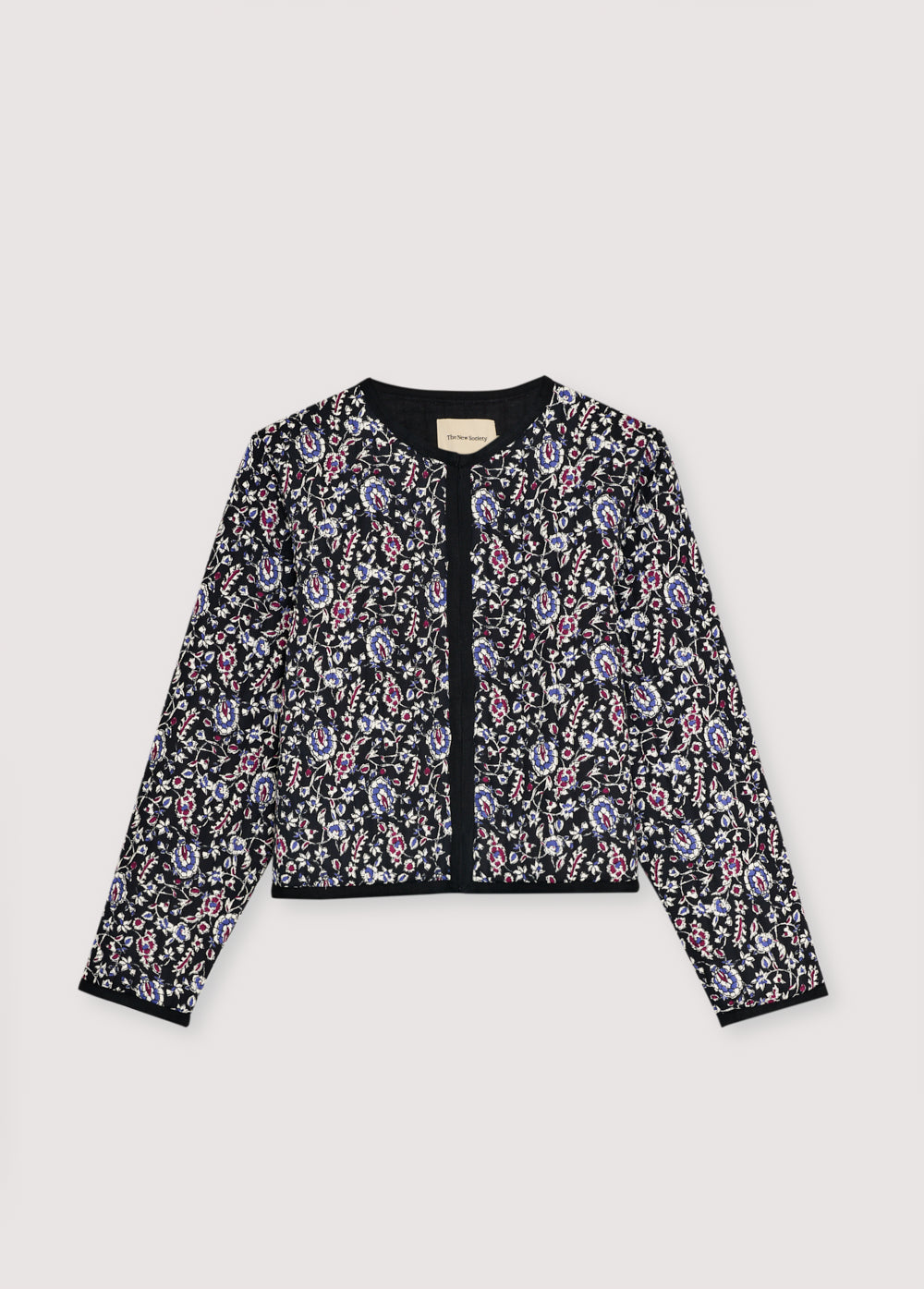 Quilted cropped jacket with a beautiful print design and finishes with a herringbone tape in tone.