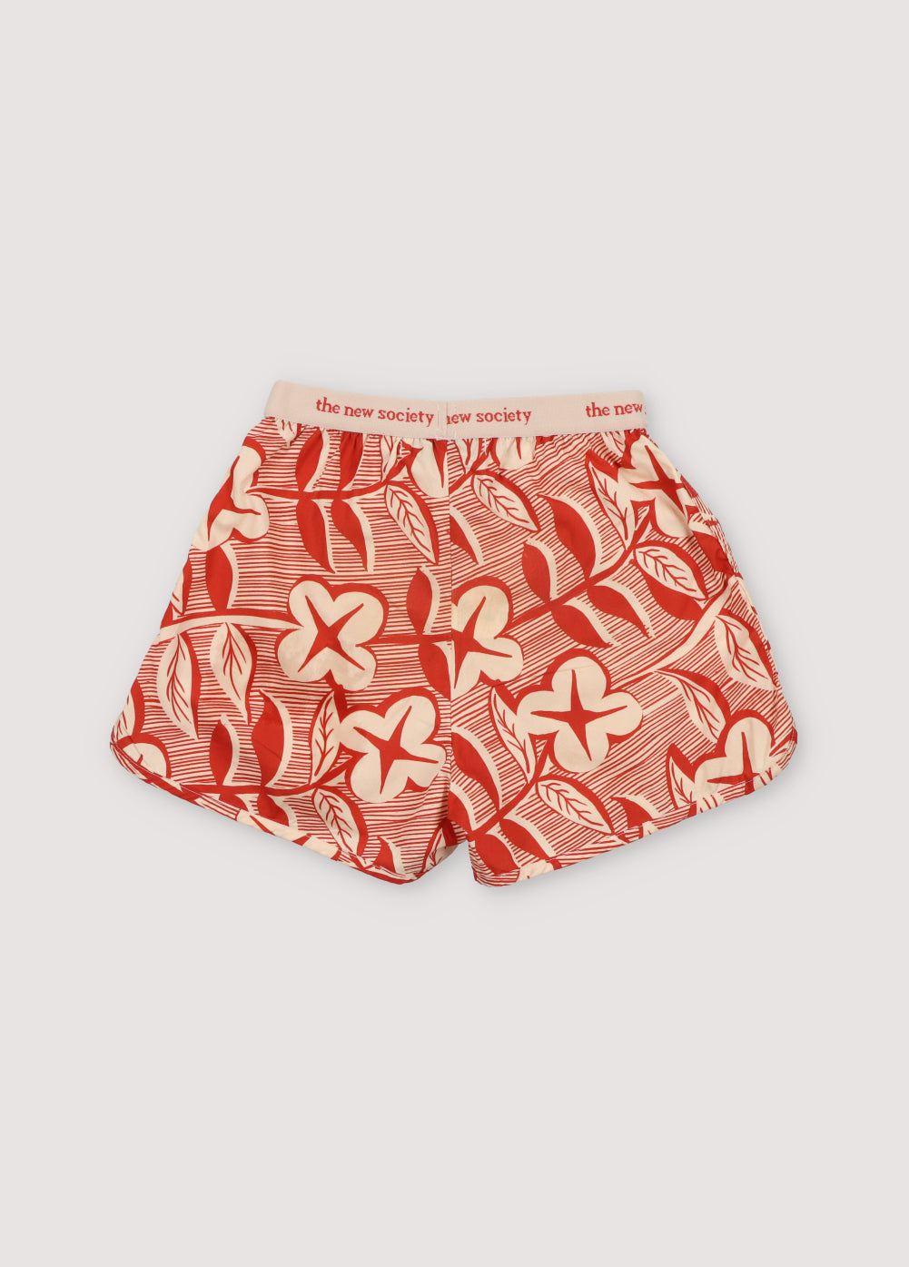 Filotis Short in 100% cotton fabric with our chili mountain rose print, featuring an elastic waistband in chili with macadamia-colored letters. Spring Summer Collection. The New Society.