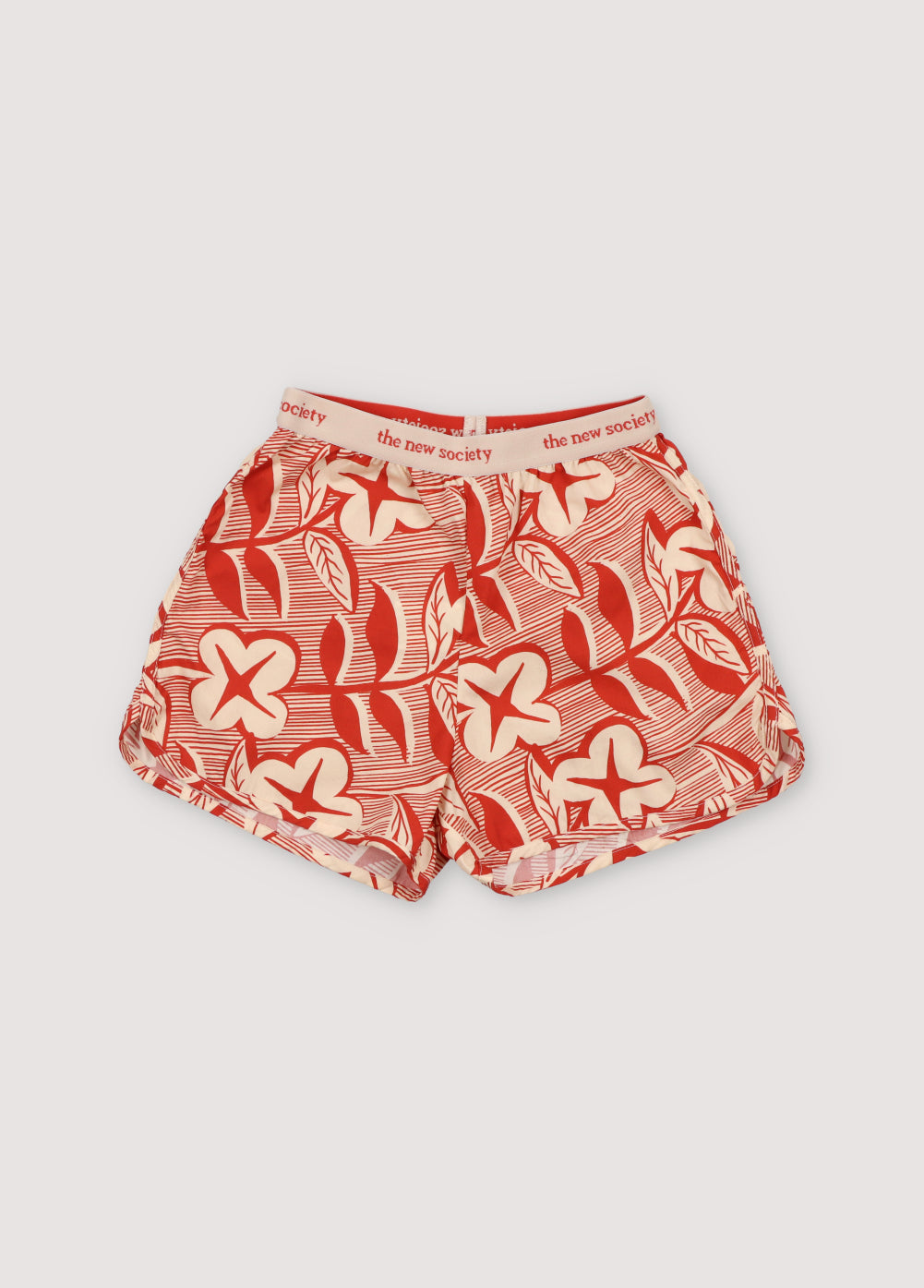 Filotis Short in 100% cotton fabric with our chili mountain rose print, featuring an elastic waistband in chili with macadamia-colored letters. Spring Summer Collection. The New Society.