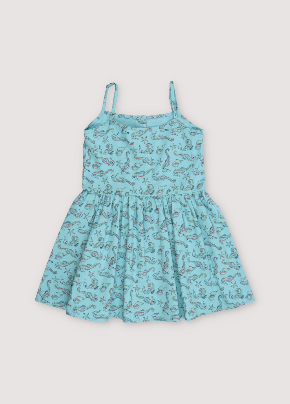 Io Dress in 100% cotton fabric with our seahorses print, featuring straps, a waist cut, voluminous skirt, and central front buttons.