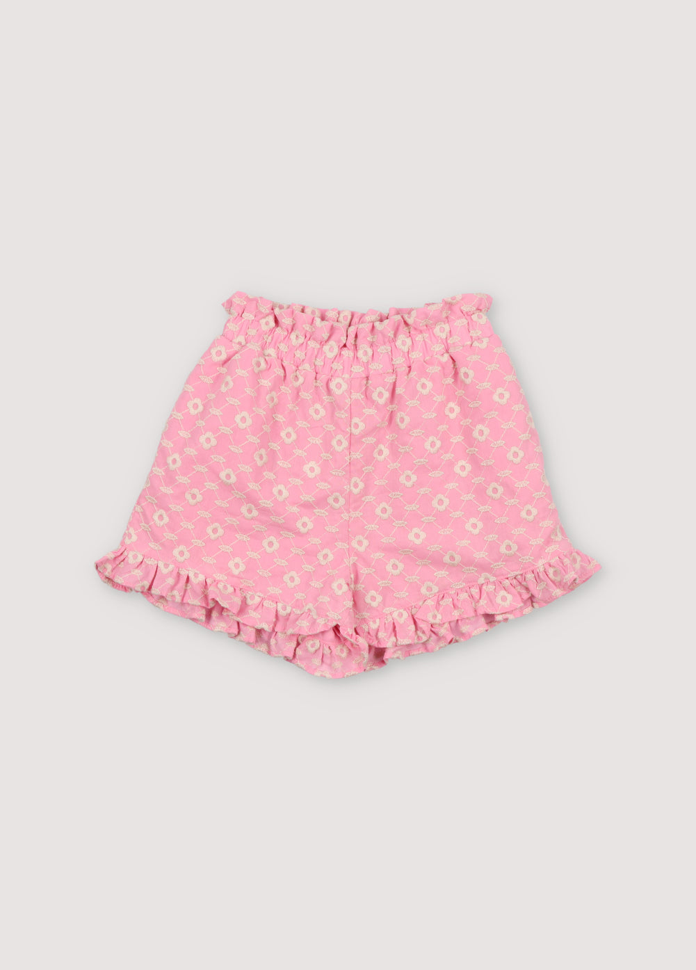 Isidora Short in hibiscus voile fabric with macadamia cot-pes embroidery. Shorts with side seam pockets, elastic waistband with drawstring, and ruffle detail at the legs.