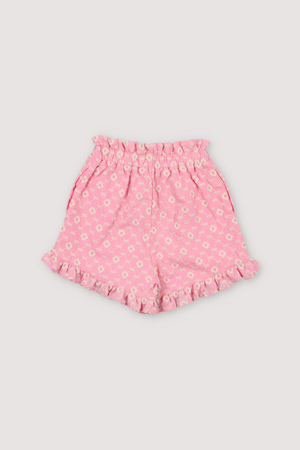 Isidora Short in hibiscus voile fabric with macadamia cot-pes embroidery. Shorts with side seam pockets, elastic waistband with drawstring, and ruffle detail at the legs.