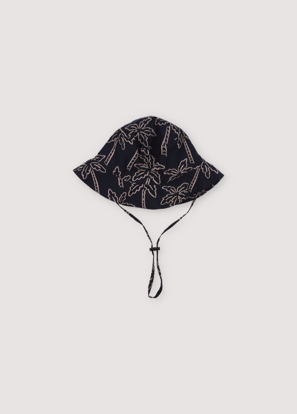 Ithaki Hat in 100% cotton fabric with our Palms Navy print, featuring a navy cord detail with matching stopper. Spring Summer Collection. The New Society.