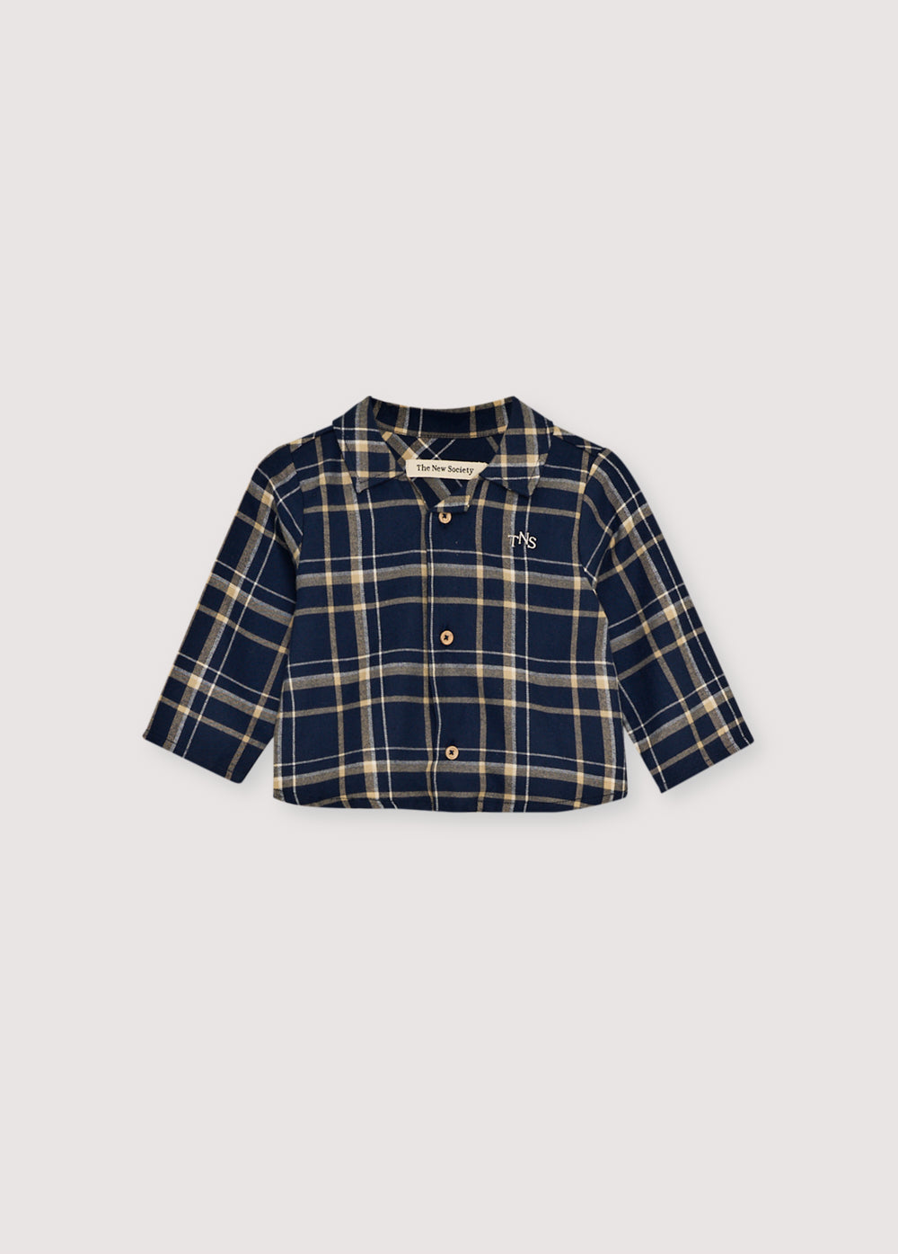 Plaid flannel shirt with wooden buttons and a TNS embroidered logo on the chest. It comes with matching trousers to create a complete look.