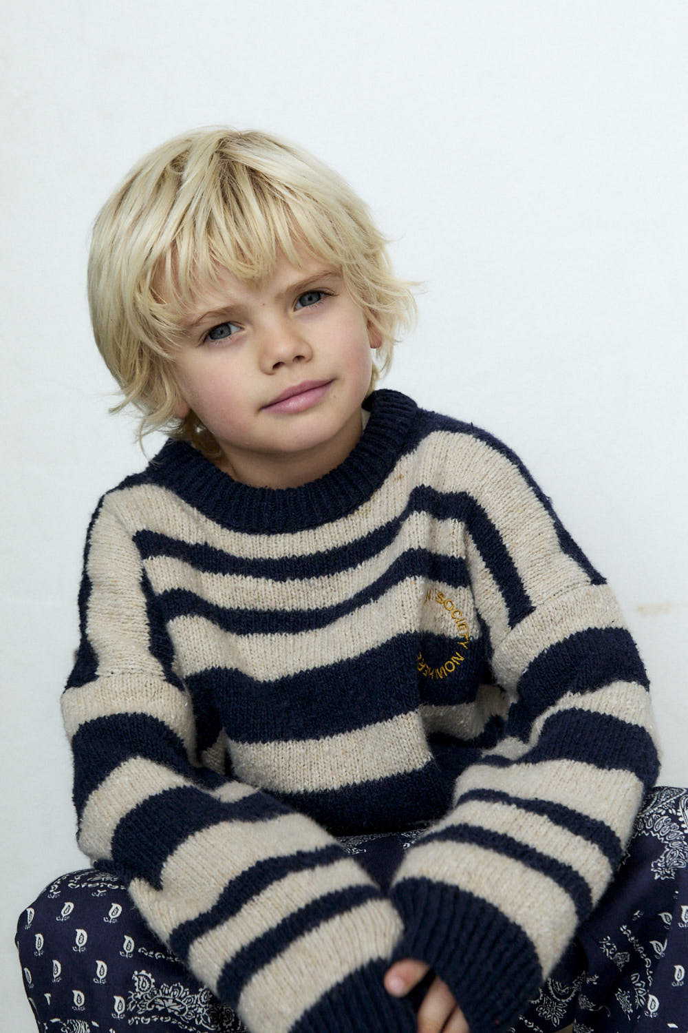 Experience timeless style with our classic striped sweater in a sophisticated two-tone colorway, featuring subtle yet eye-catching contrasting embroidery on the chest.