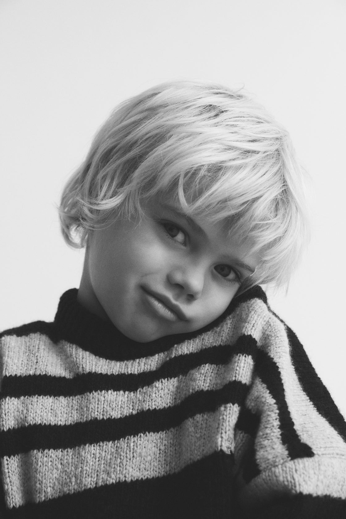 Experience timeless style with our classic striped sweater in a sophisticated two-tone colorway, featuring subtle yet eye-catching contrasting embroidery on the chest.