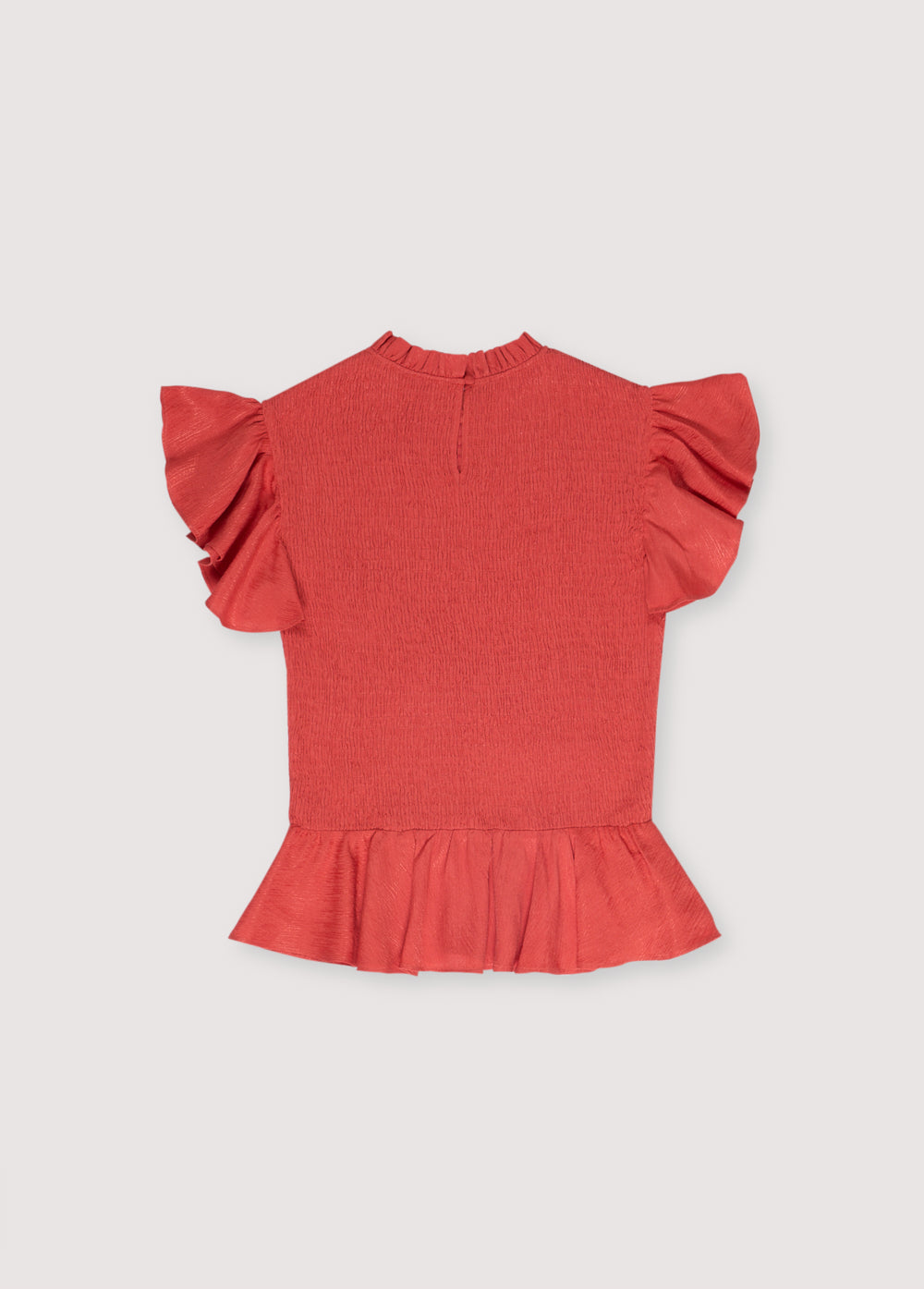 Jacquard woven blouse in a lovely chili color with smocking on the body and ruffles at the waist and shoulders.