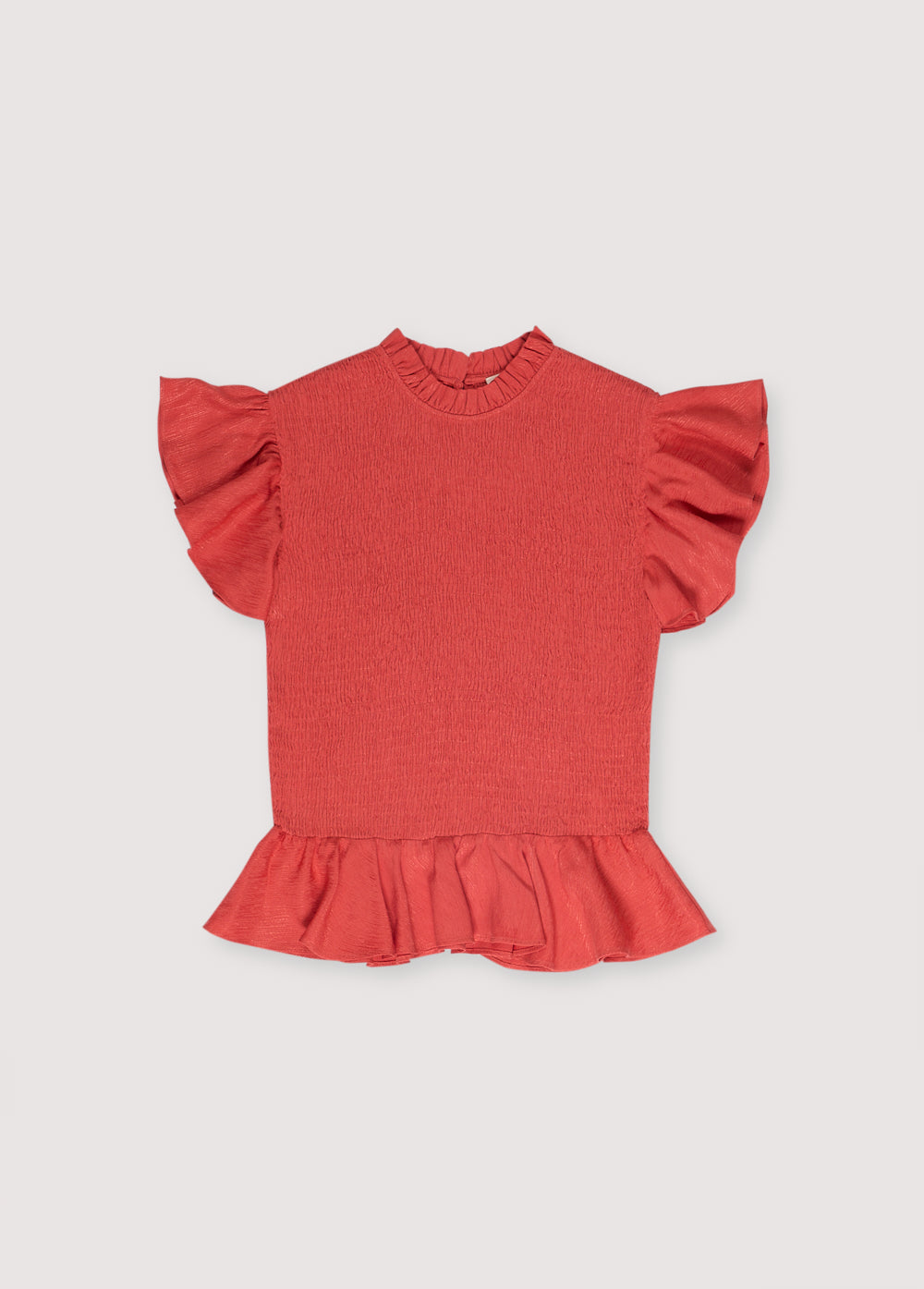 Jacquard woven blouse in a lovely chili color with smocking on the body and ruffles at the waist and shoulders.