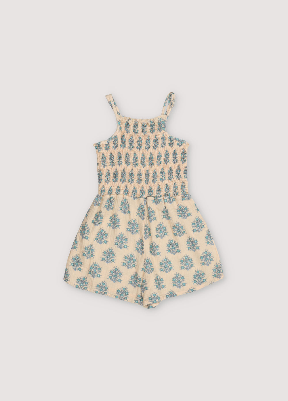 Kyra Jumpsuit in muslin fabric with our Lavender print. Jumpsuit with a smocked top and gathered pants creating the smocking effect for the upper part.