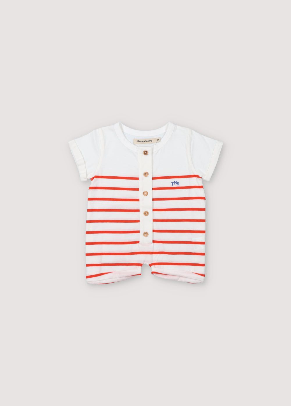 Baby romper with bicolor stripes, short sleeves, and a front placket with wooden buttons. It features a playful contrast embroidery on the chest. Spring Summer Collection. The New Society.