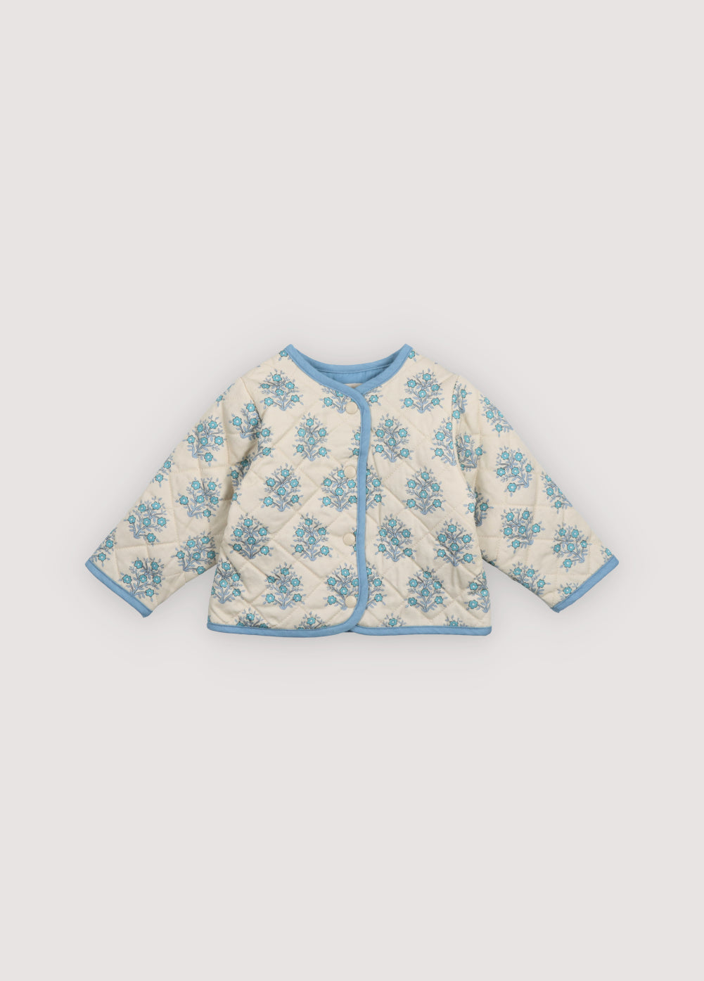 Kyra Baby Jacket in 100% cotton twill and chambray fabric with our Lavender print. Jacket with a crew neckline, chambray finishing details, and central closure with snaps matching the background of the print. Spring Summer Collection. The New Society.