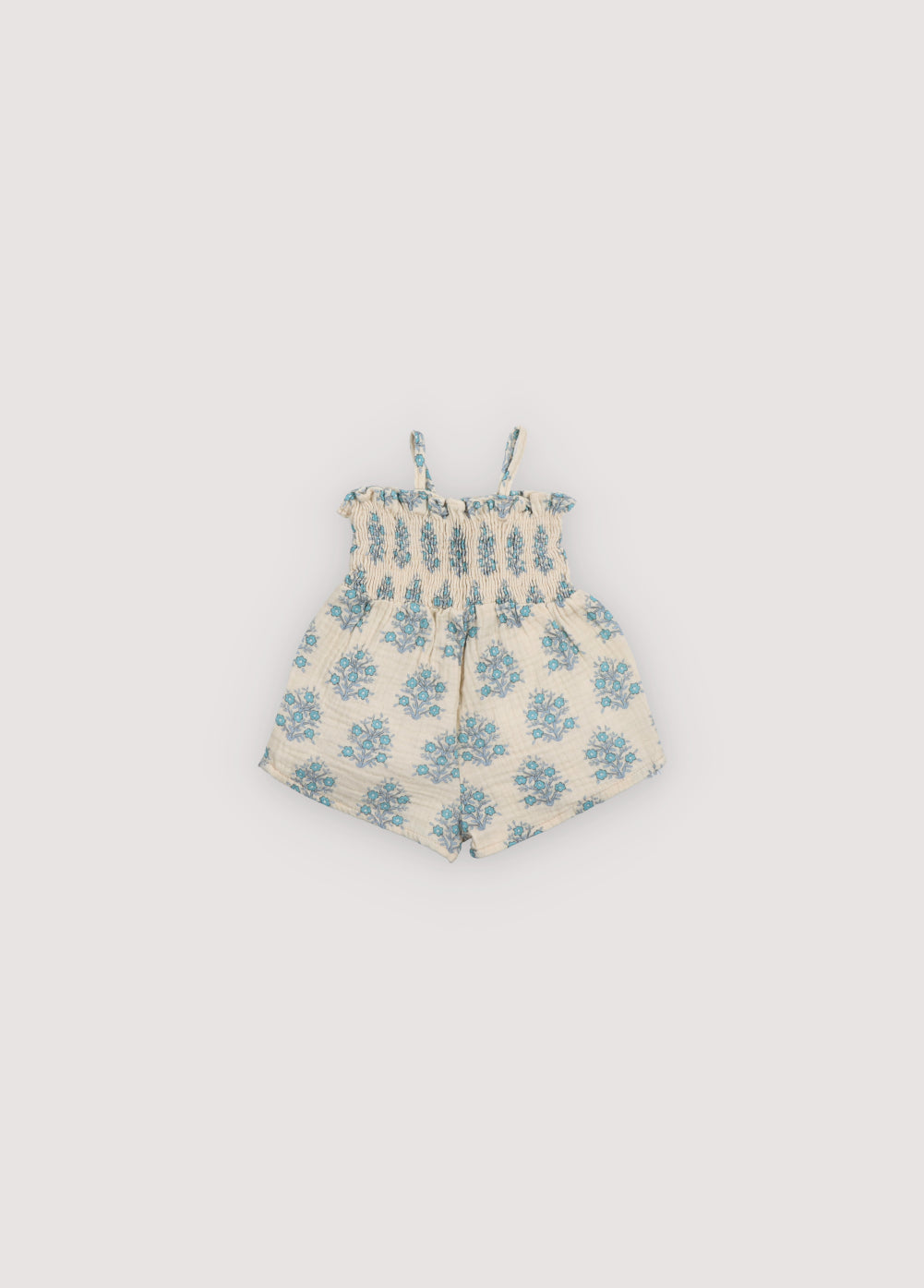 Kyra Baby Jumpsuit in muslin fabric with our Lavender print. Jumpsuit with a smocked top and gathered pants creating the smocking effect for the upper part. Spring Summer Collection. The New Society.