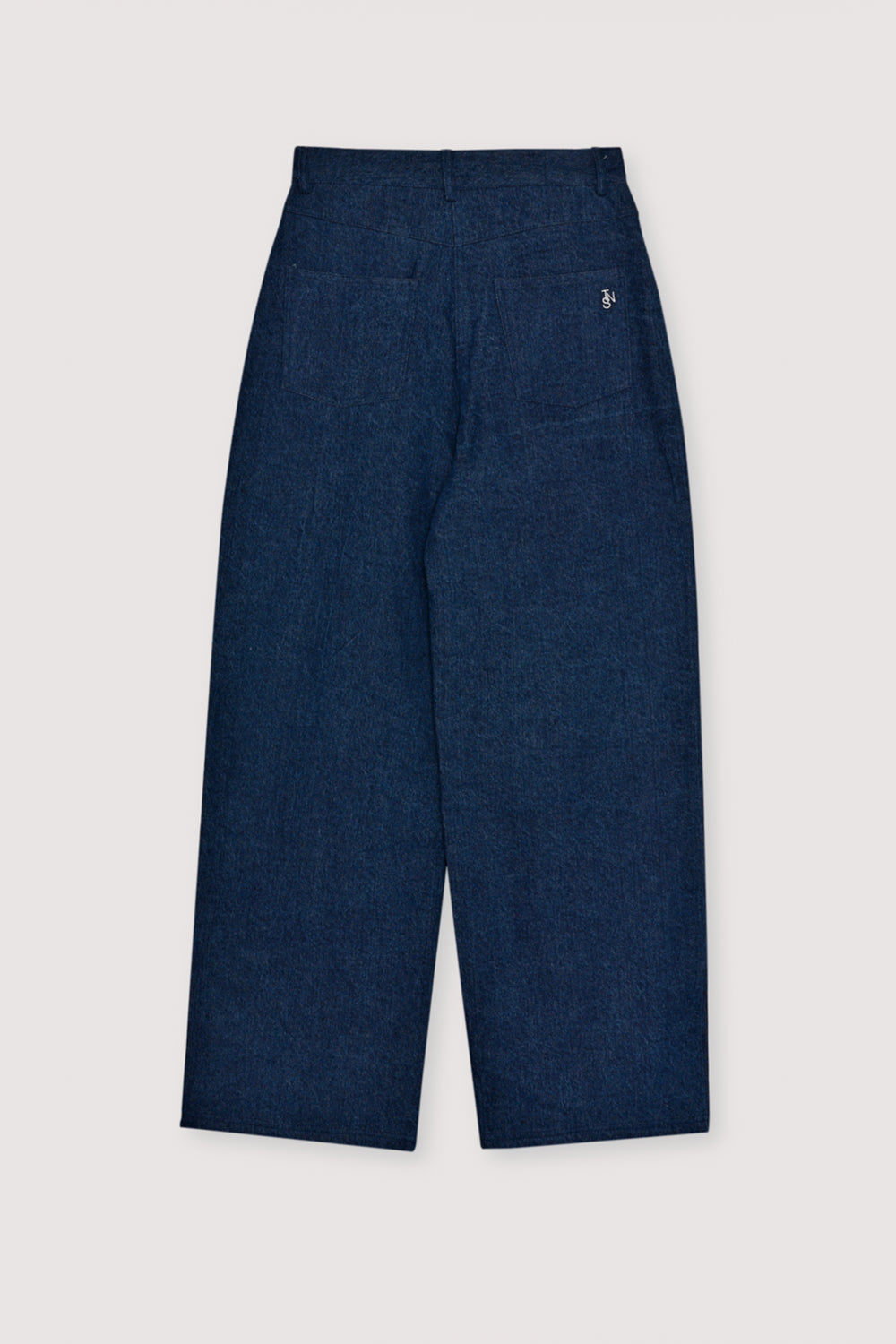 Wide-leg denim pant with delicate hand-applied crystal details at the front. It features patch pockets at the back and TNS embroidery on the waistband.