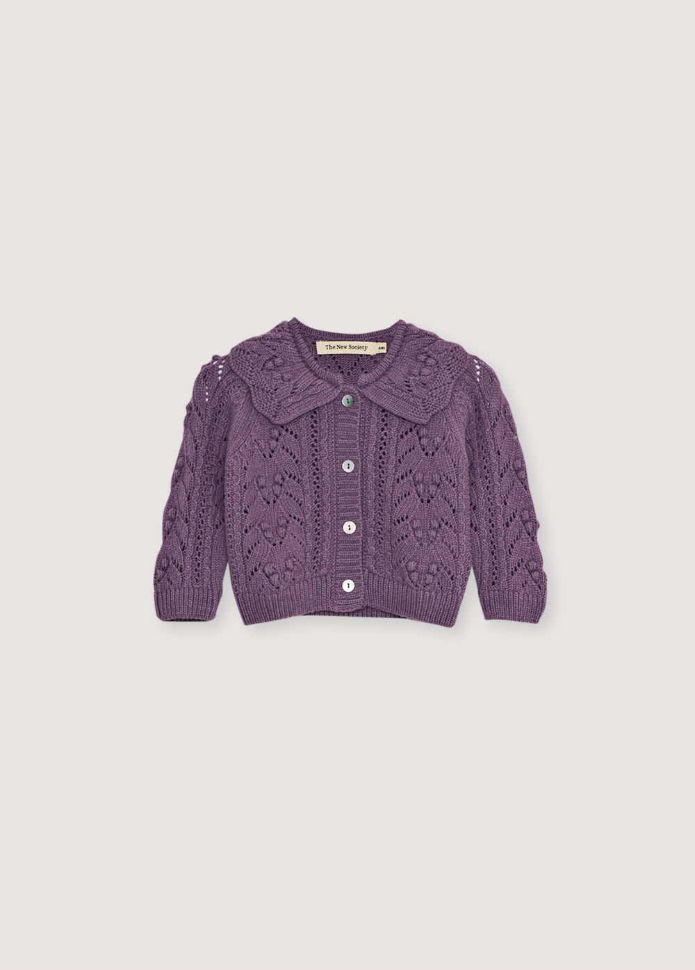 Cashmere and wool all recycled cardigan with a beautiful knit design and a ribbed collar detail. It features a front opening with mother-of-pearl buttons. It comes with matching leggings to create a beautiful complete look.