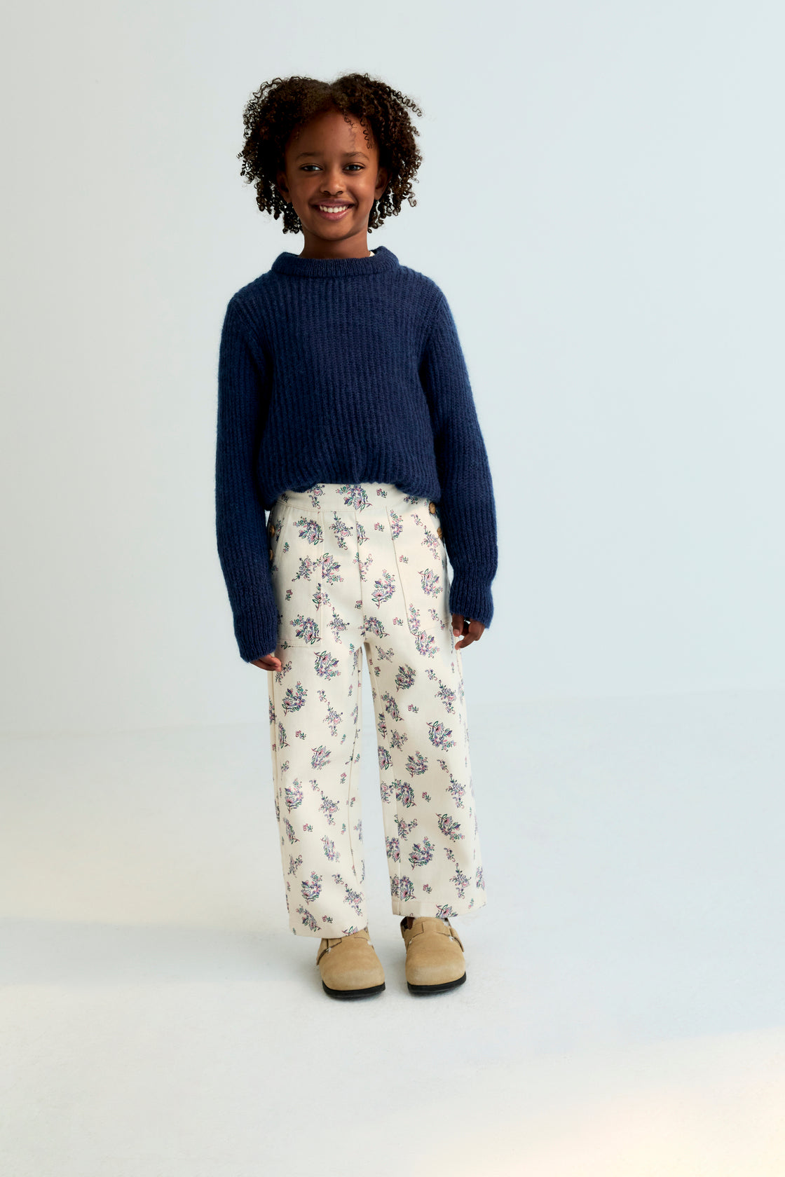 Fine rib knit mohair sweater with a round neckline and ribbing at the neck, cuffs, and hem. It feautures a TNS embroidery on tone on hem rib.