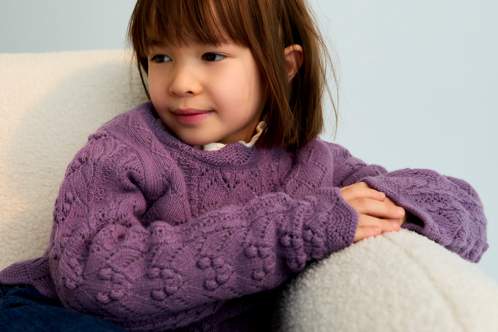 Recycled cashmere and wool knit sweater with beautiful curved finishes on the neckline, cuffs, and hem. It comes with a matching skirt to create a complete look.