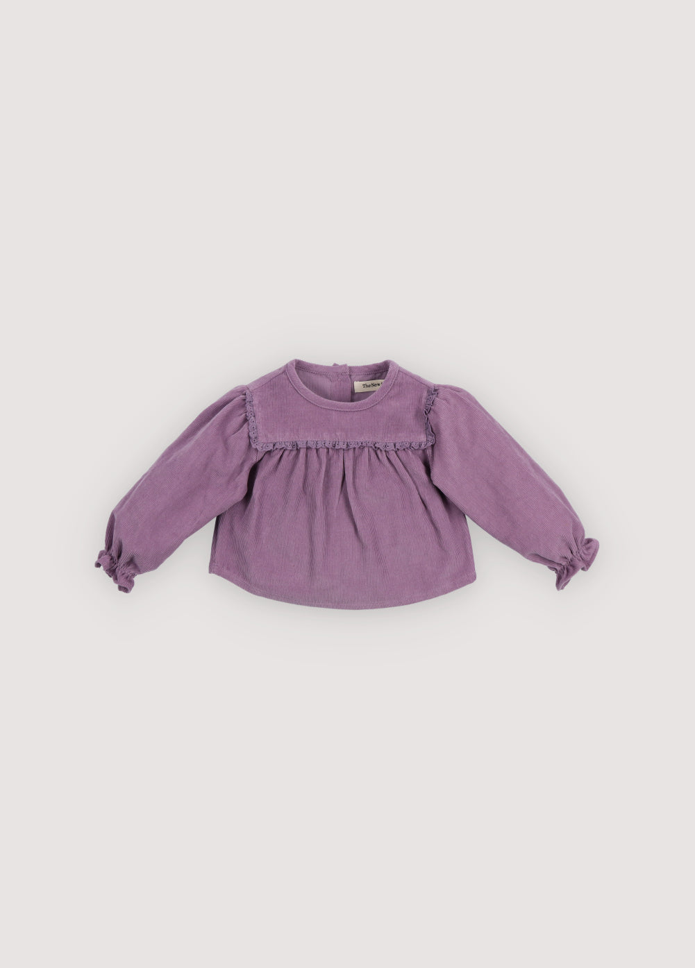 Micro-corduroy blouse with tone-on-tone lace detail at the front yokes and a back opening with wooden buttons. It comes with matching trousers to create a total look.