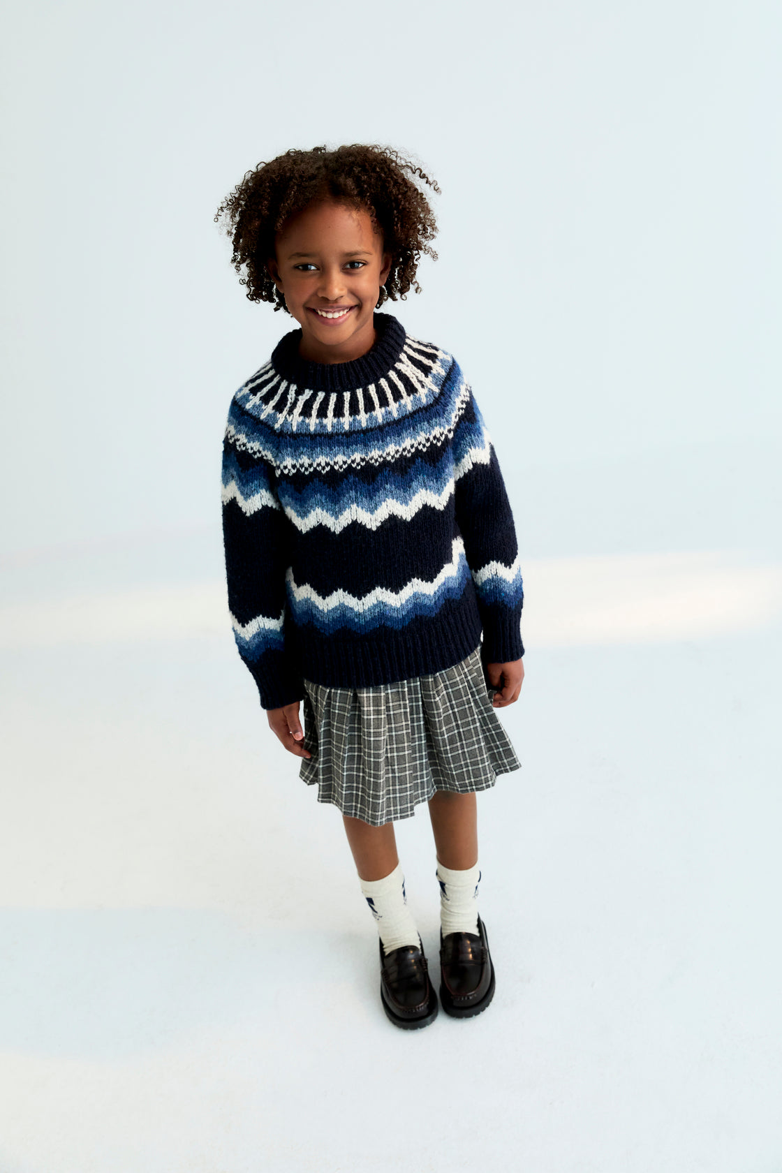 A chic pleated skirt featuring a comfortable inner pant lining for ease of movement. Designed with a fitted waistband, belt loops, and a tonal side zipper for a clean, refined finish.