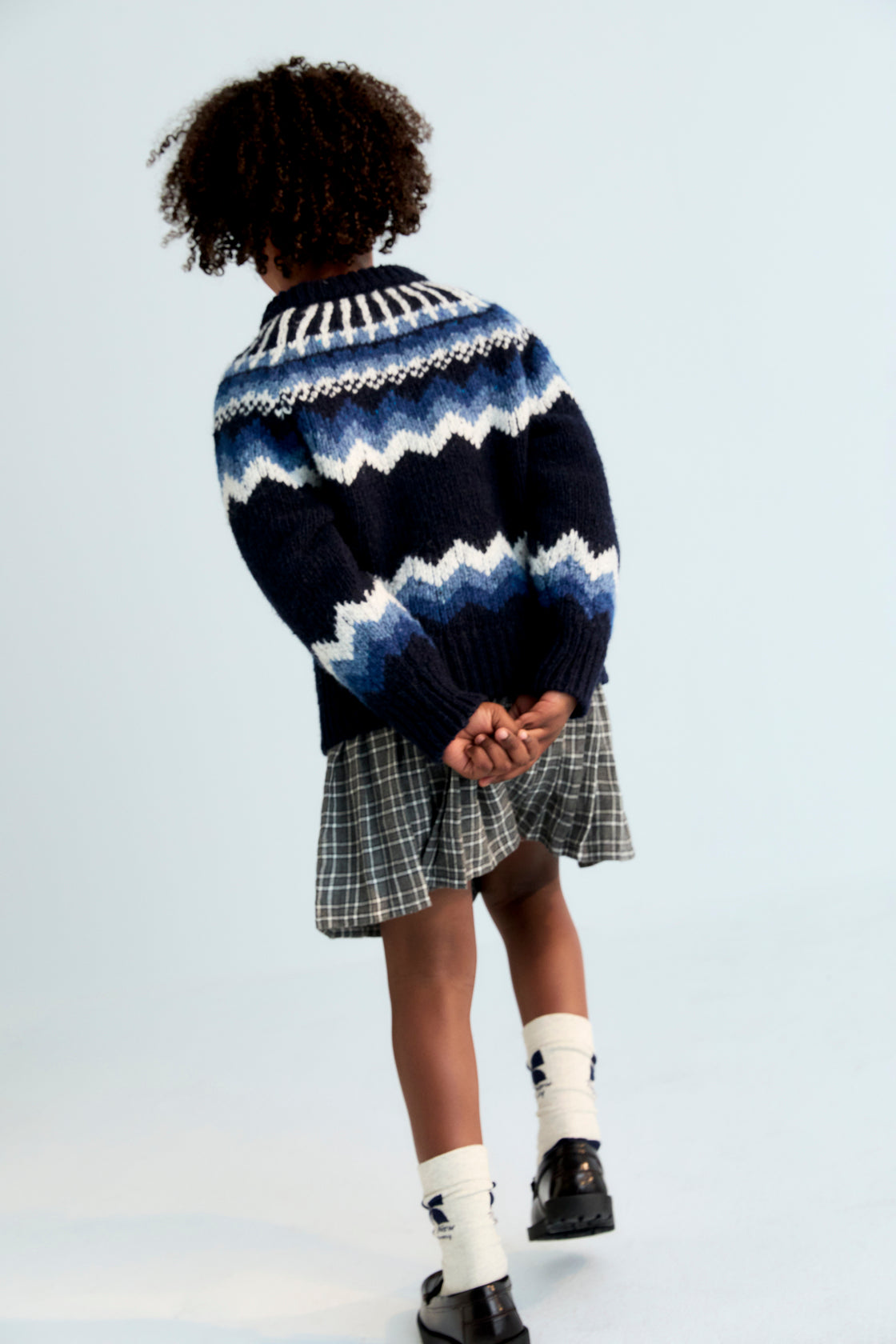 A chic pleated skirt featuring a comfortable inner pant lining for ease of movement. Designed with a fitted waistband, belt loops, and a tonal side zipper for a clean, refined finish.