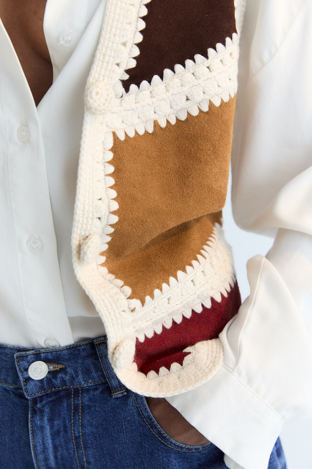 This vest is a special piece made in Spain, crafted from leather in various colors and handwoven wool crochet. A perfect piece to pair with the matching skirt.