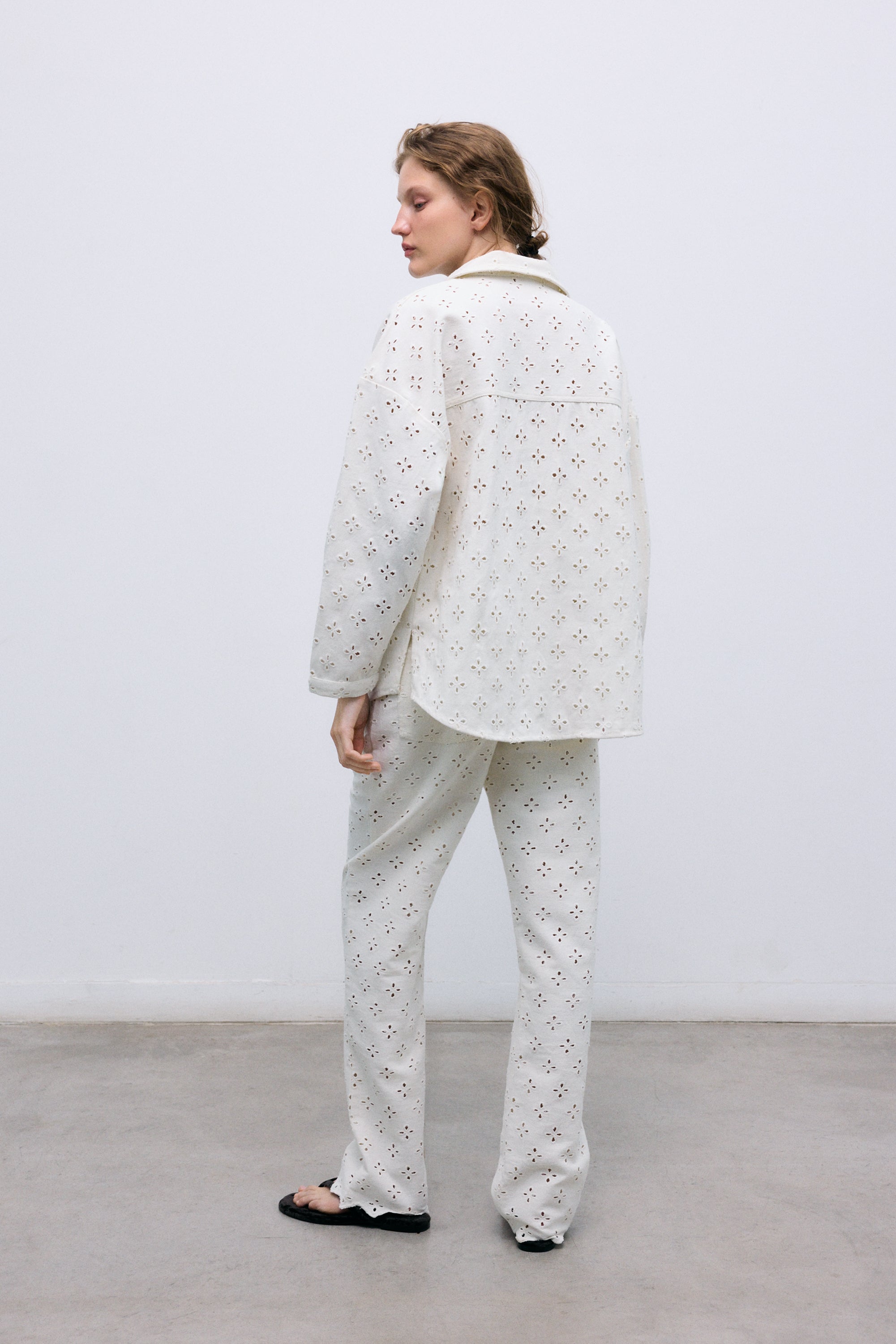 Denim pants crafted from a delicate fabric with all-over embroidery for a refined and unique finish.