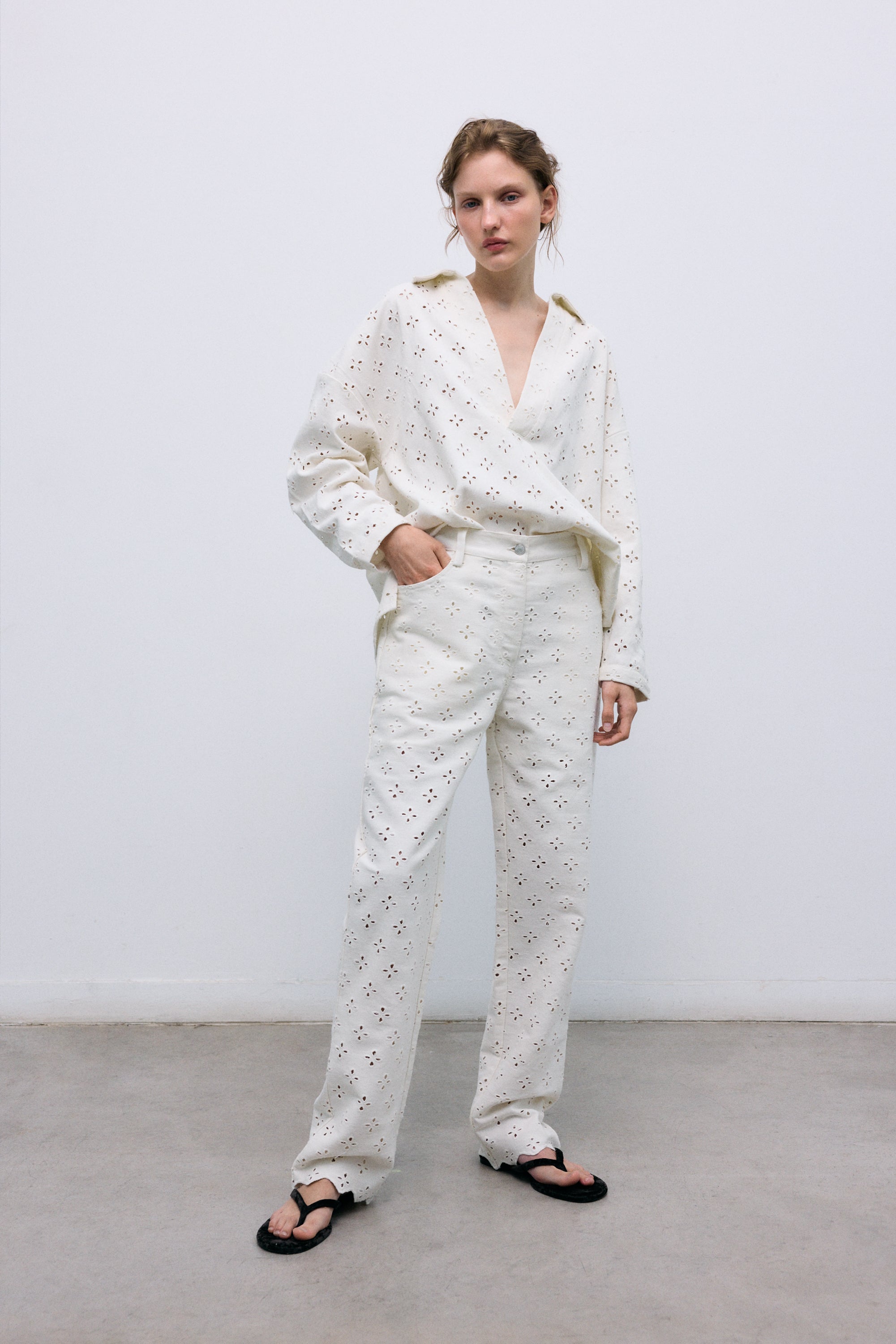 Polo-style blouse with a shirt collar and front opening, crafted from a delicate and special denim fabric featuring all-over embroidery for a unique textured finish