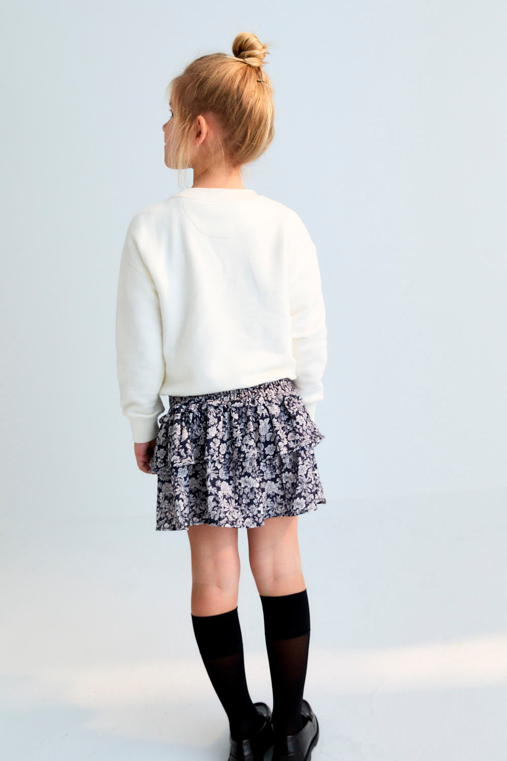 Our timeless classic skirt features smocking at the waist and delicate double ruffles, crafted from soft floral-printed double gauze fabric
