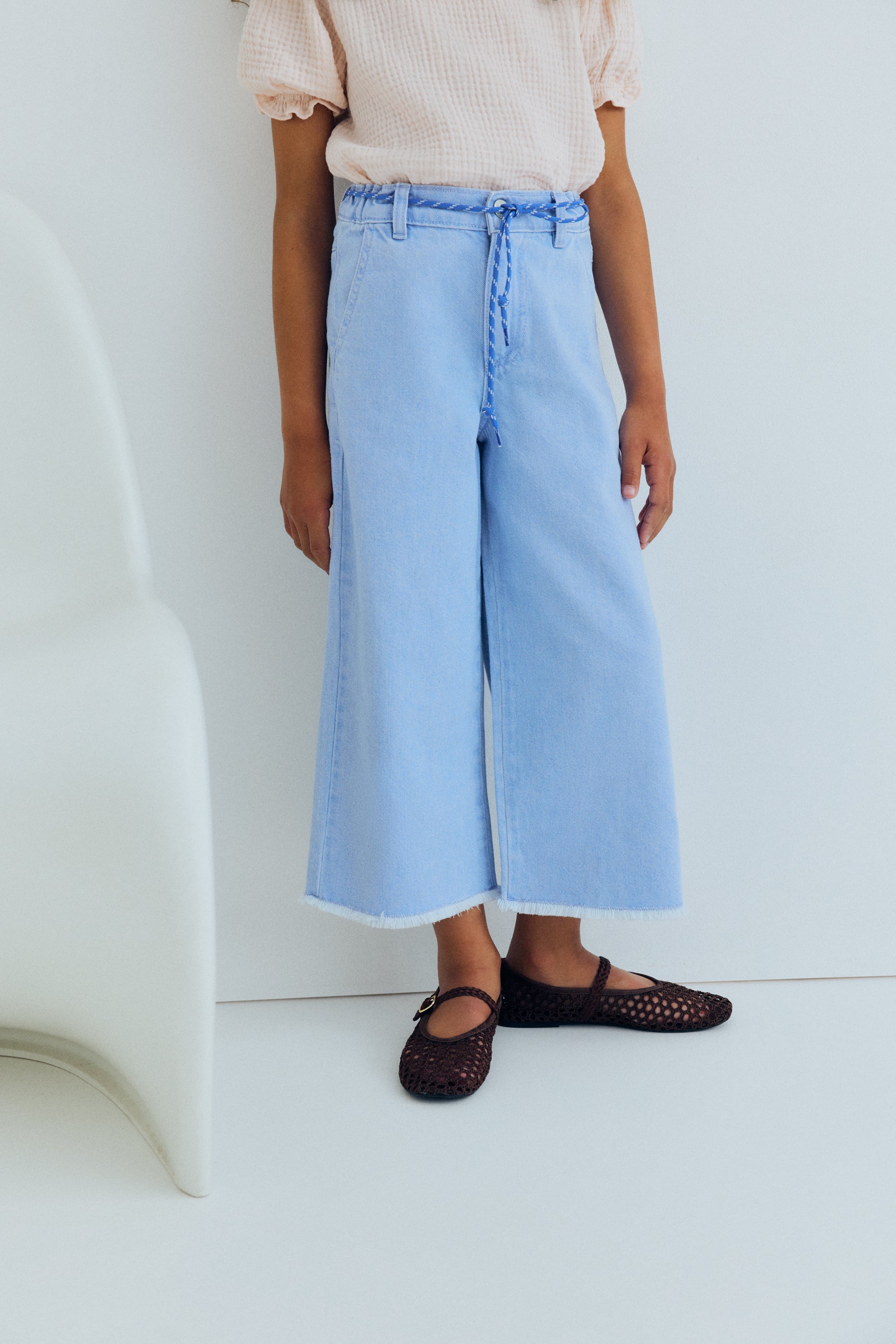 Wide leg denim pants in a soft washed finish, featuring straight legs and an adjustable waistband with interior elastic