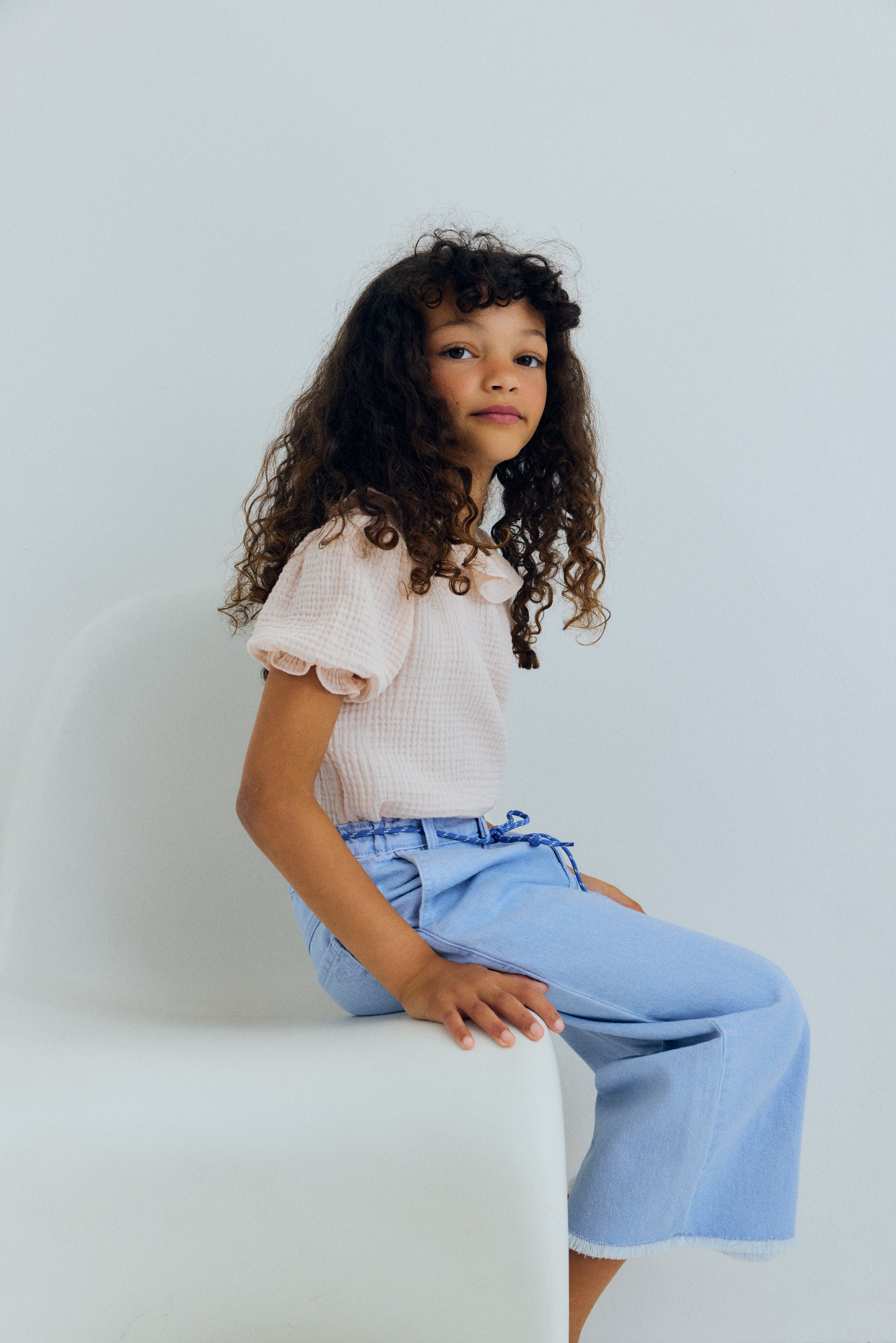 Wide leg denim pants in a soft washed finish, featuring straight legs and an adjustable waistband with interior elastic